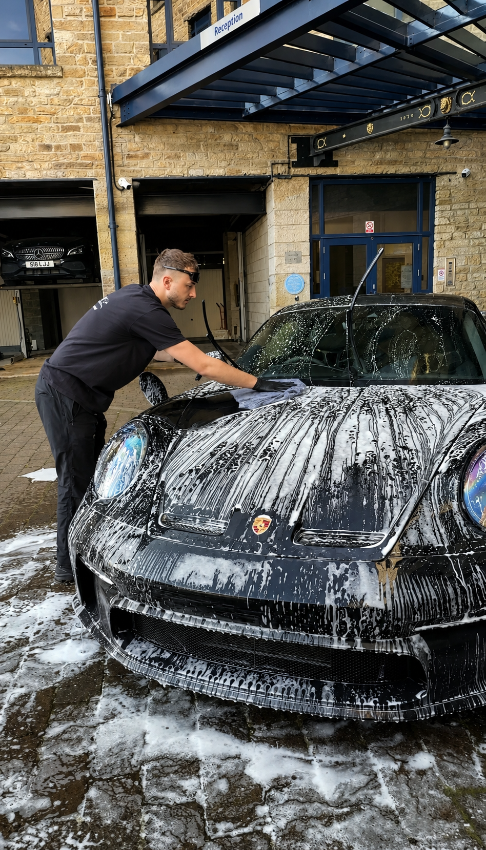 Lewis from LT Detailing cleaning a car during a mobile detailing service in West Yorkshire