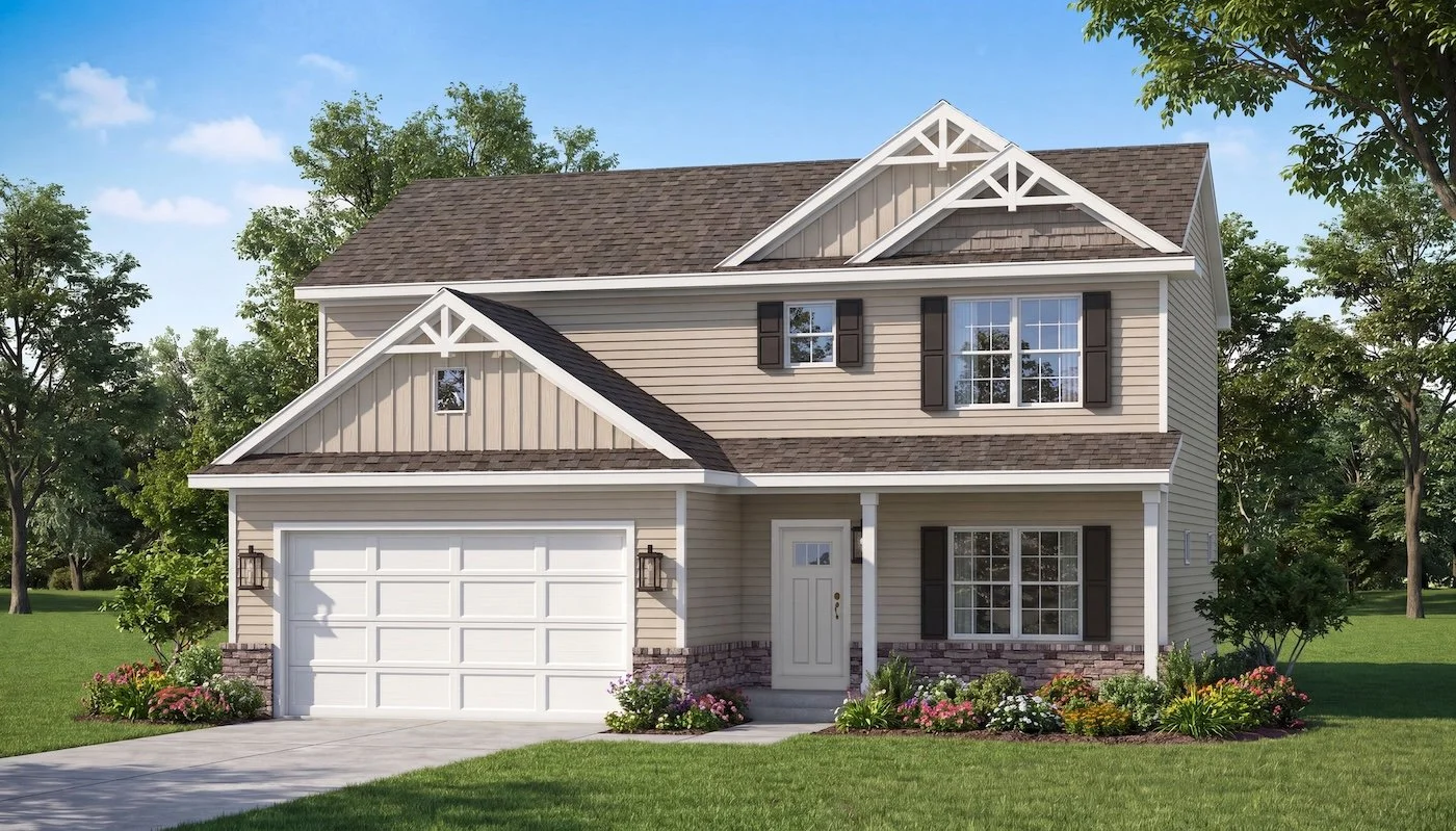 A two-story suburban house with beige siding, white trim, a brown shingle roof, and a two-car garage. The house has black shutters, a front porch with a white door, and landscaping with flowers and bushes. Tall trees and a green lawn surround the house against a blue sky.