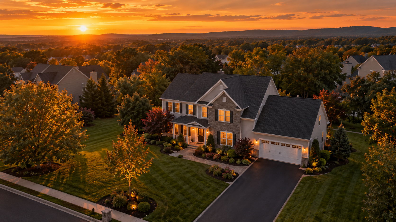 Illustrative aerial view of a suburban property at sunset