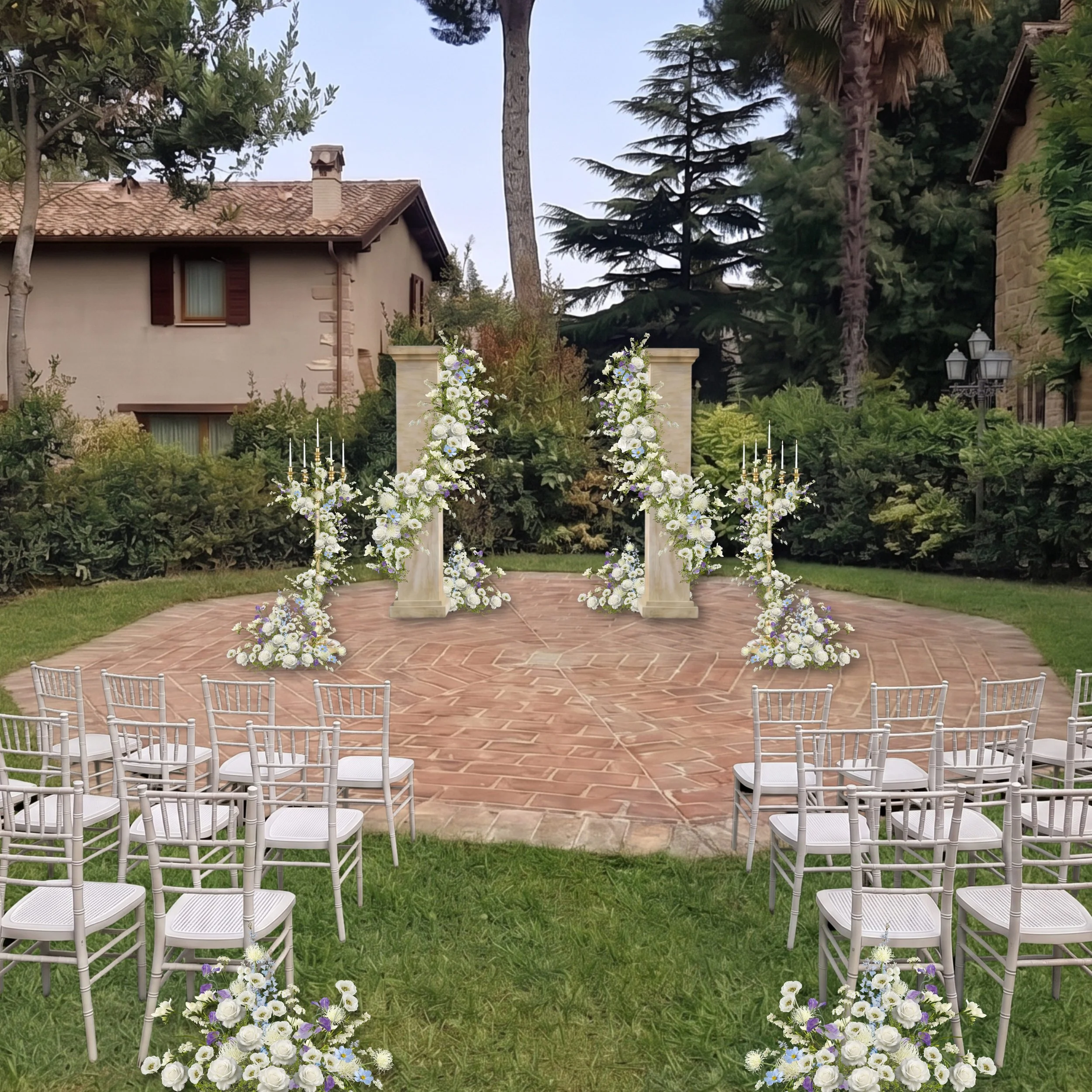 Wedding altar set outdoors with white chairs arranged in rows, decorated with white and purple flowers, on a brick patio surrounded by greenery and trees.