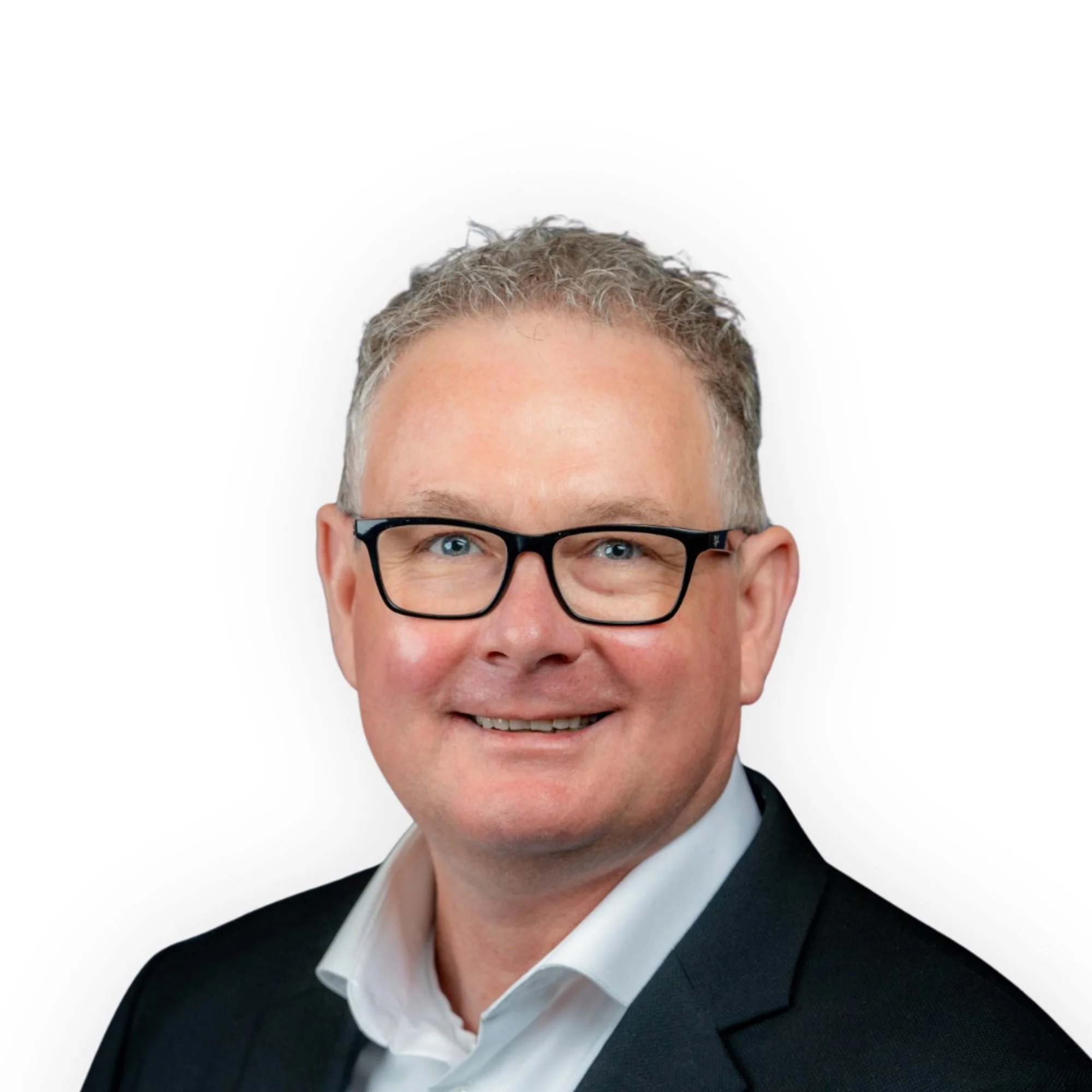 Professional headshot of a man with glasses, short gray hair, wearing a dark suit and white shirt, smiling, against a white background.