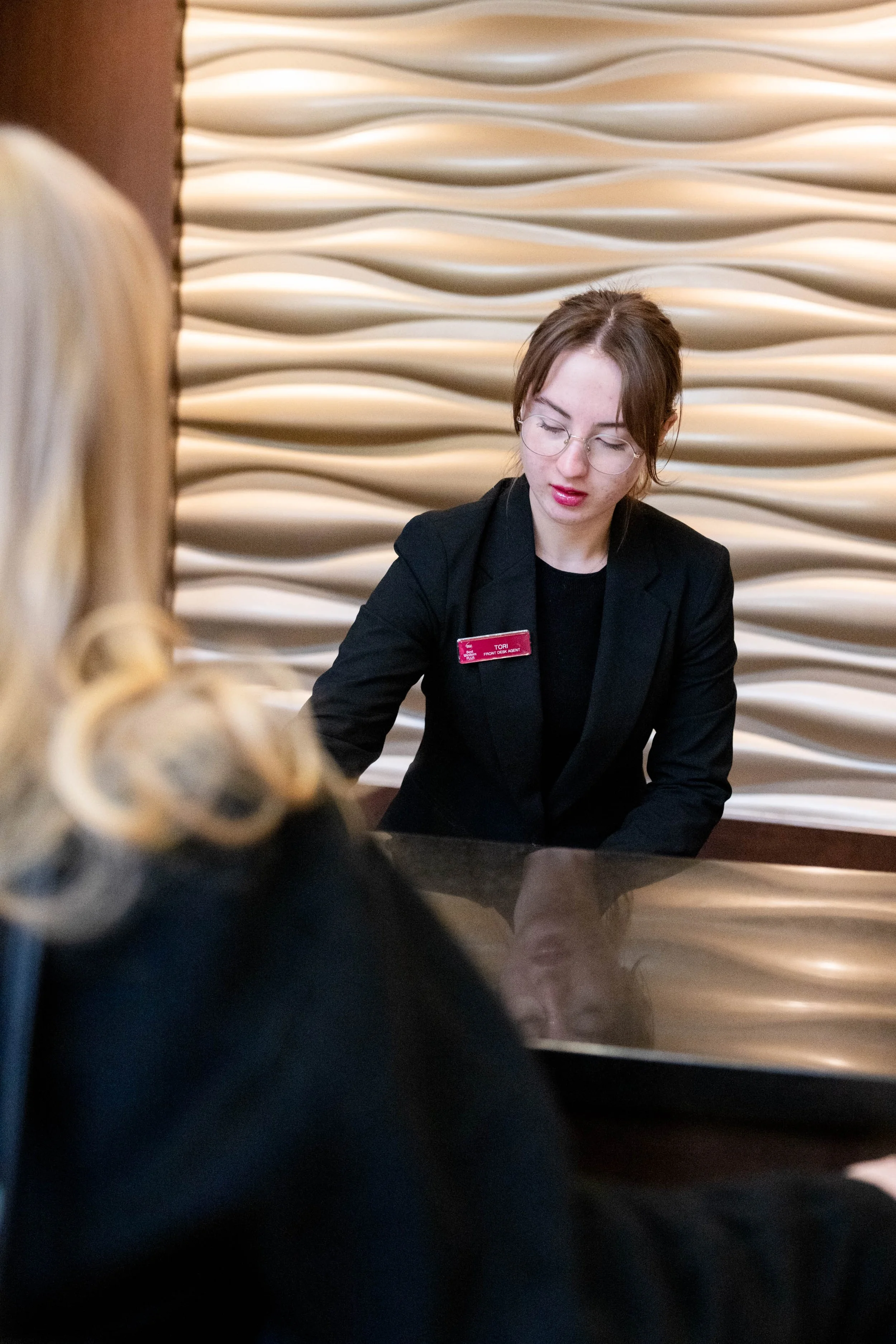 Best Western Plus Edmonton Airport Hotel team member checking in a guest