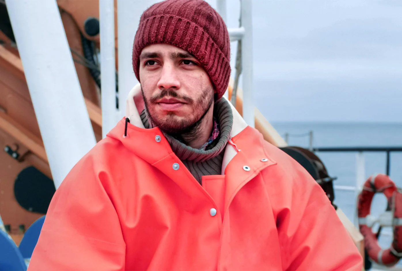 Local fisherman wearing a vibrant red jacket.