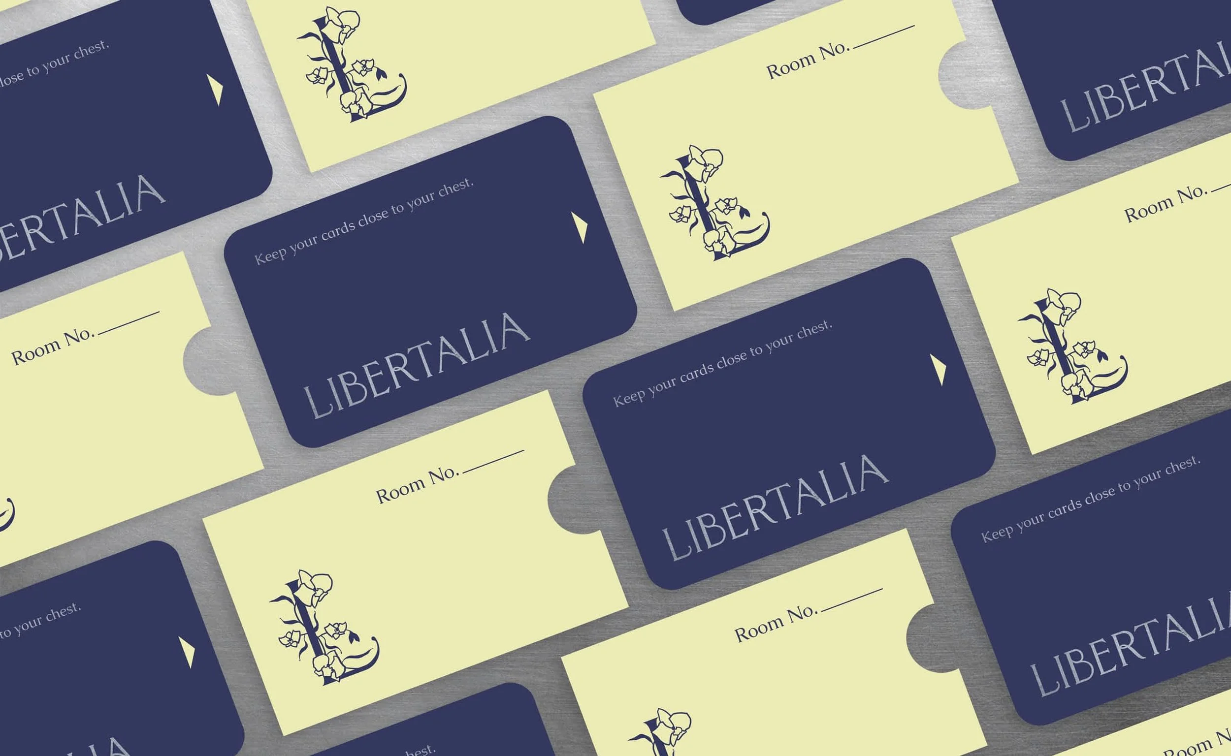 branded keycards for luxury hotel brand libertalia featuring logotype, monogram logo. Cards say keep your cards close to your chest.