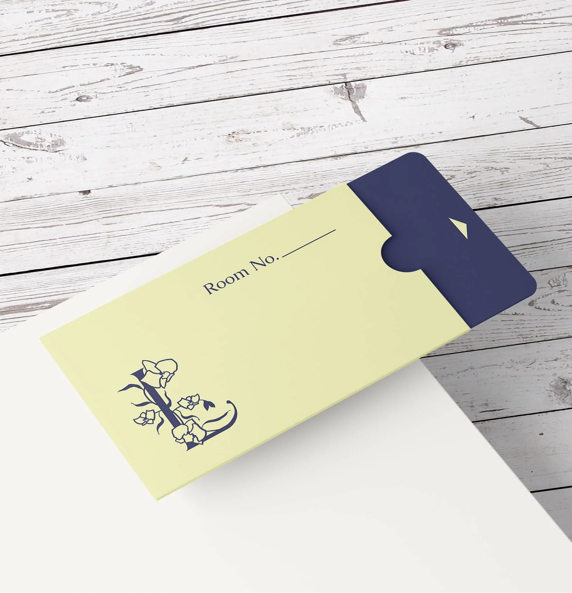 branded keycard for libertalia featuring monogram logo with L and orchid that impliesa skull