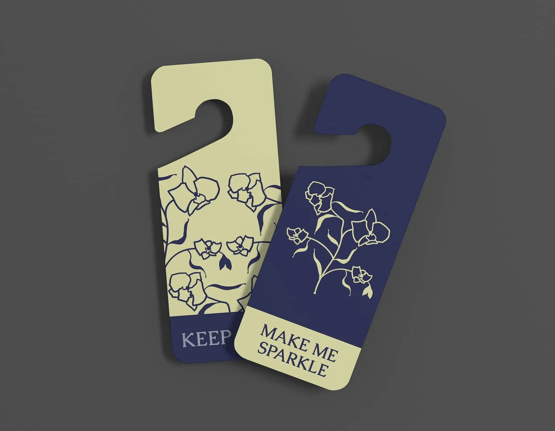 Example of hotel branding for libertalia. Two door hangers (keep out and make me sparkle) feature a tesselated flower image that forms an implicit skull.