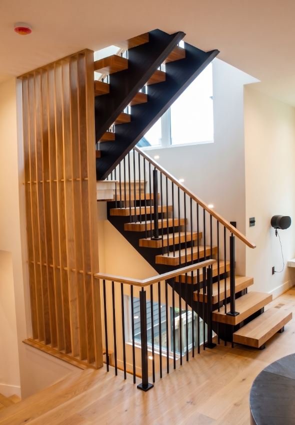 A masterfully constructed custom staircase leading to a newly added second floor in Atlanta, GA, showcasing seamless architectural integration and luxury craftsmanship by Mahfoud Construction Inc.