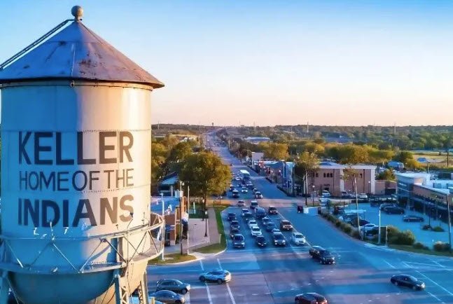 Keller water tower overlooking the street and nearby businesses in Keller, Texas