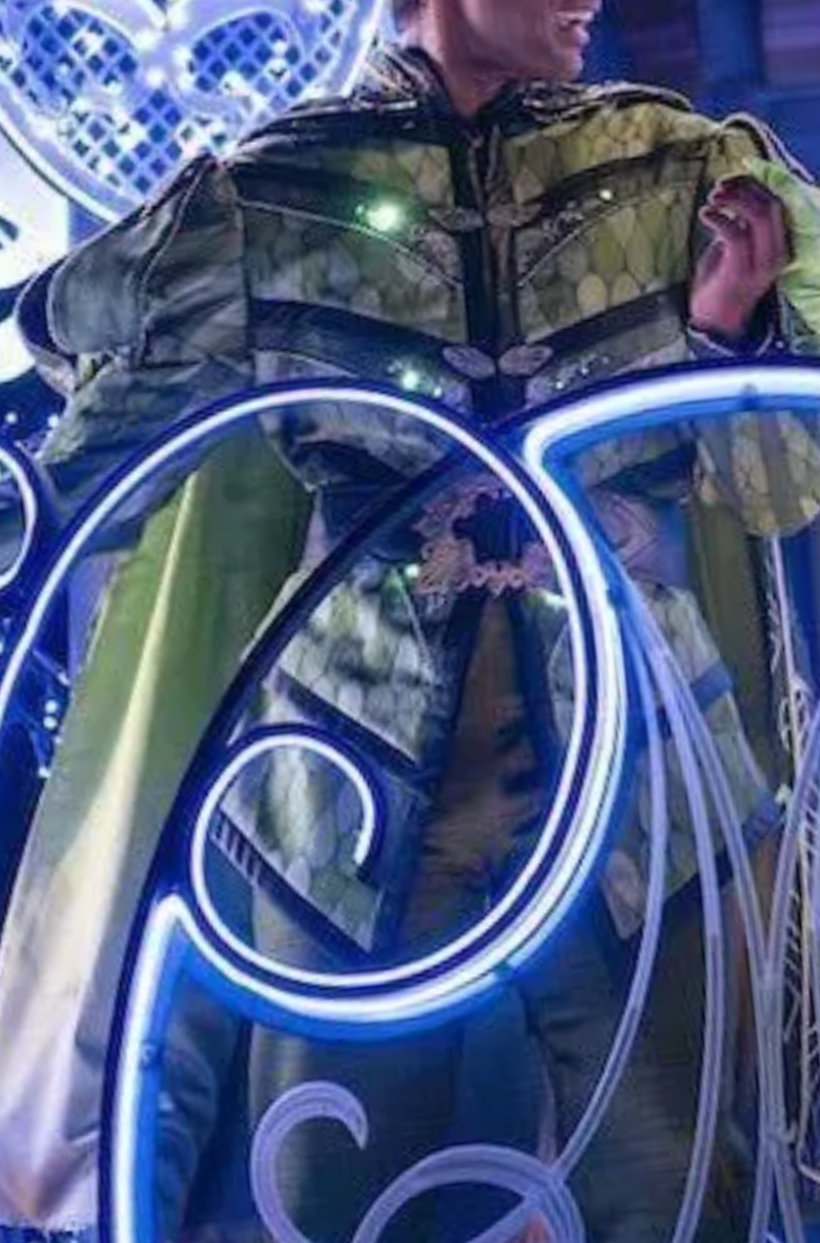 A regal prince in a shining nighttime parade wears a unique take on his traditional look , including complex and visually interesting designs and textures.