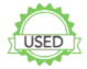 Green circular object with a logo resembling a road with a car, typical of a road safety or driving school sign.