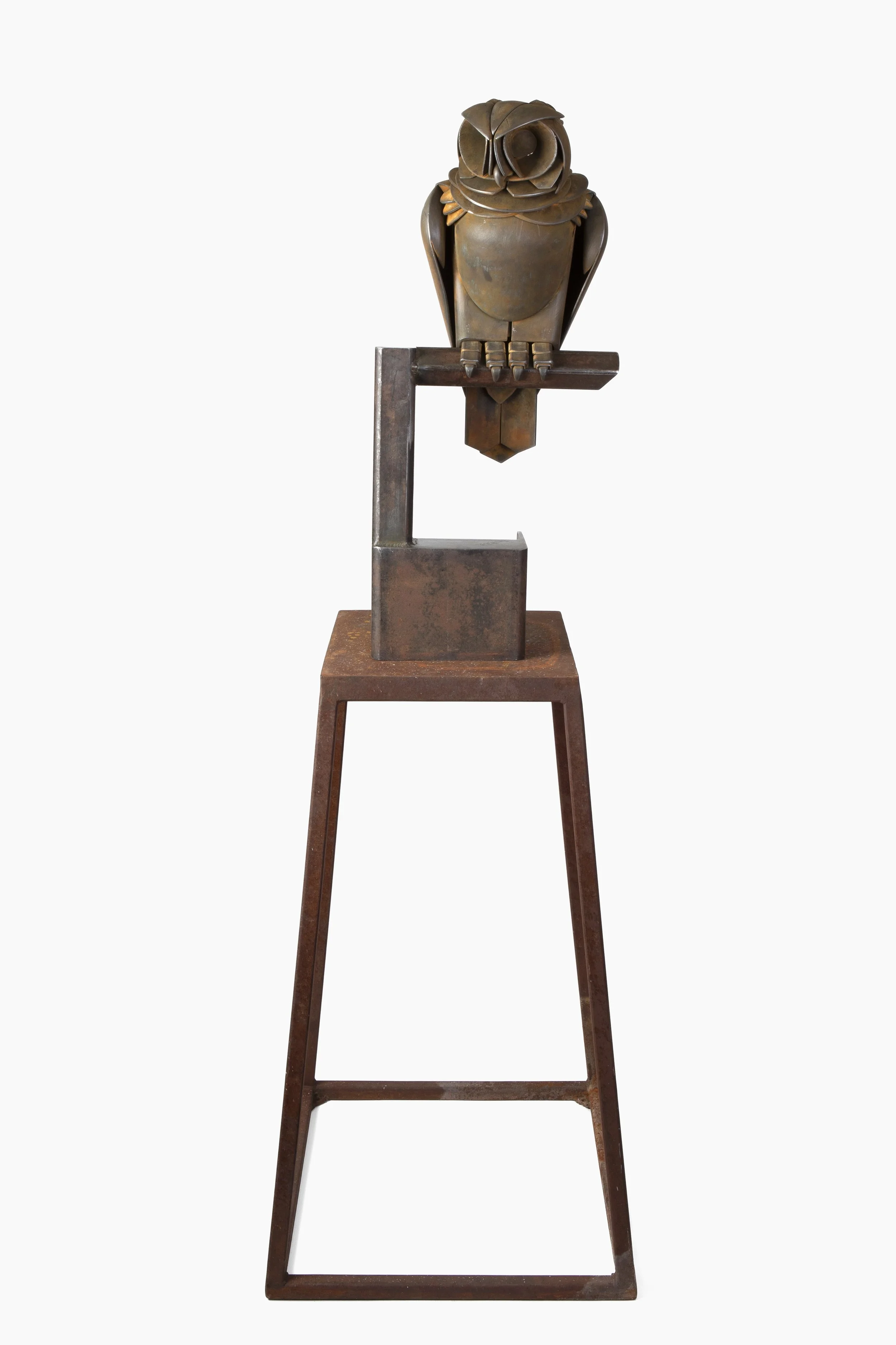 Metal sculpture of an owl perched on a minimalist stand against a plain white background.