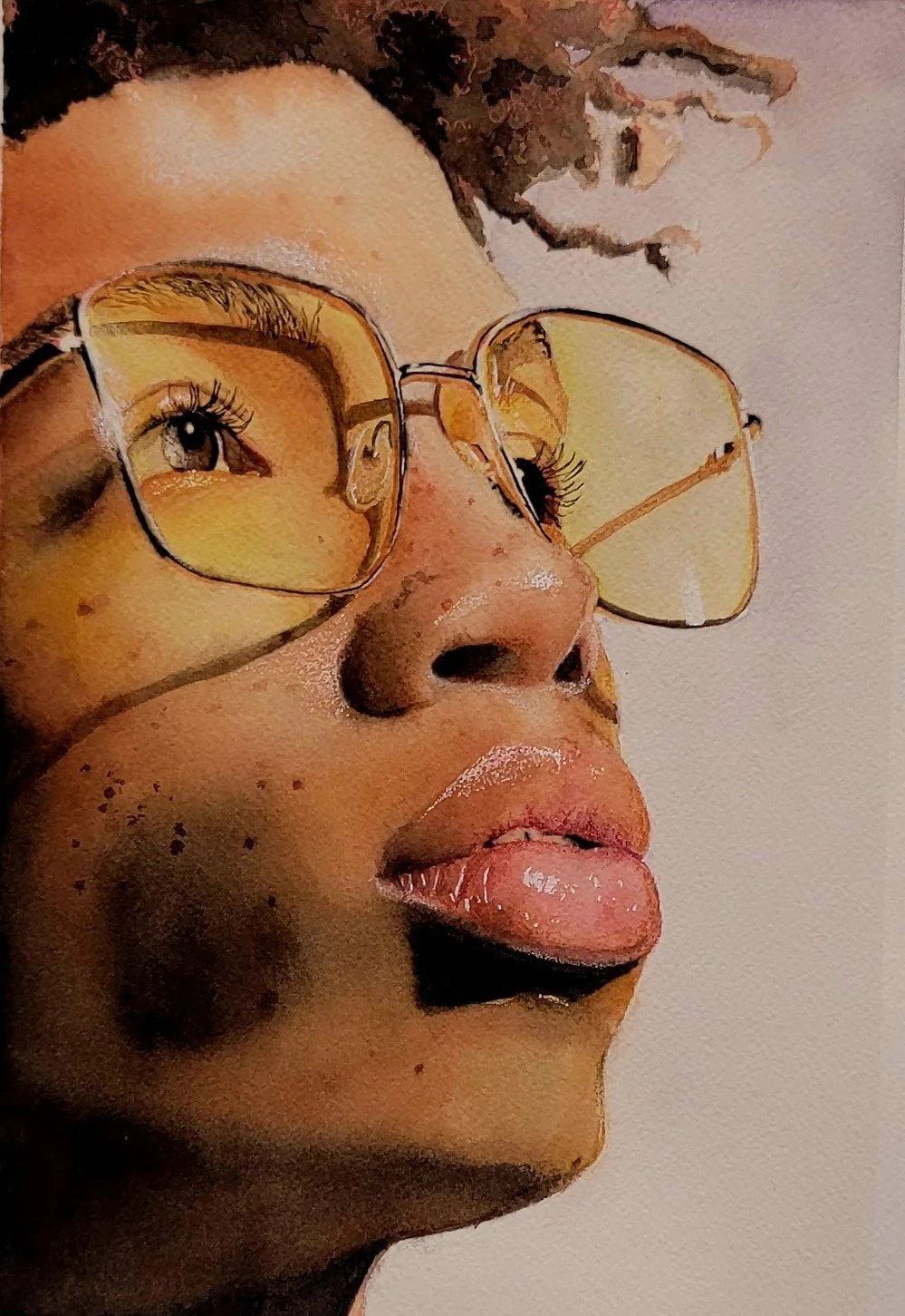 Close-up of a person's face with glasses that have yellow-tinted lenses, showing their eye and lips, against a plain background.