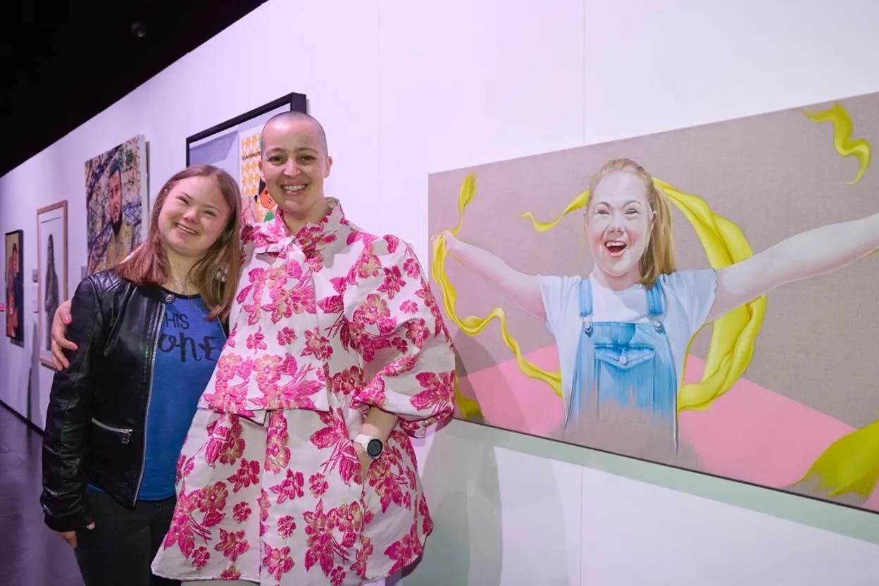 Artist Karen Turner (right) with Millie Anna (left) and her portrait that was featured in season 4 of Extraordinary Portraits Credit: Steve Lake (BBC)