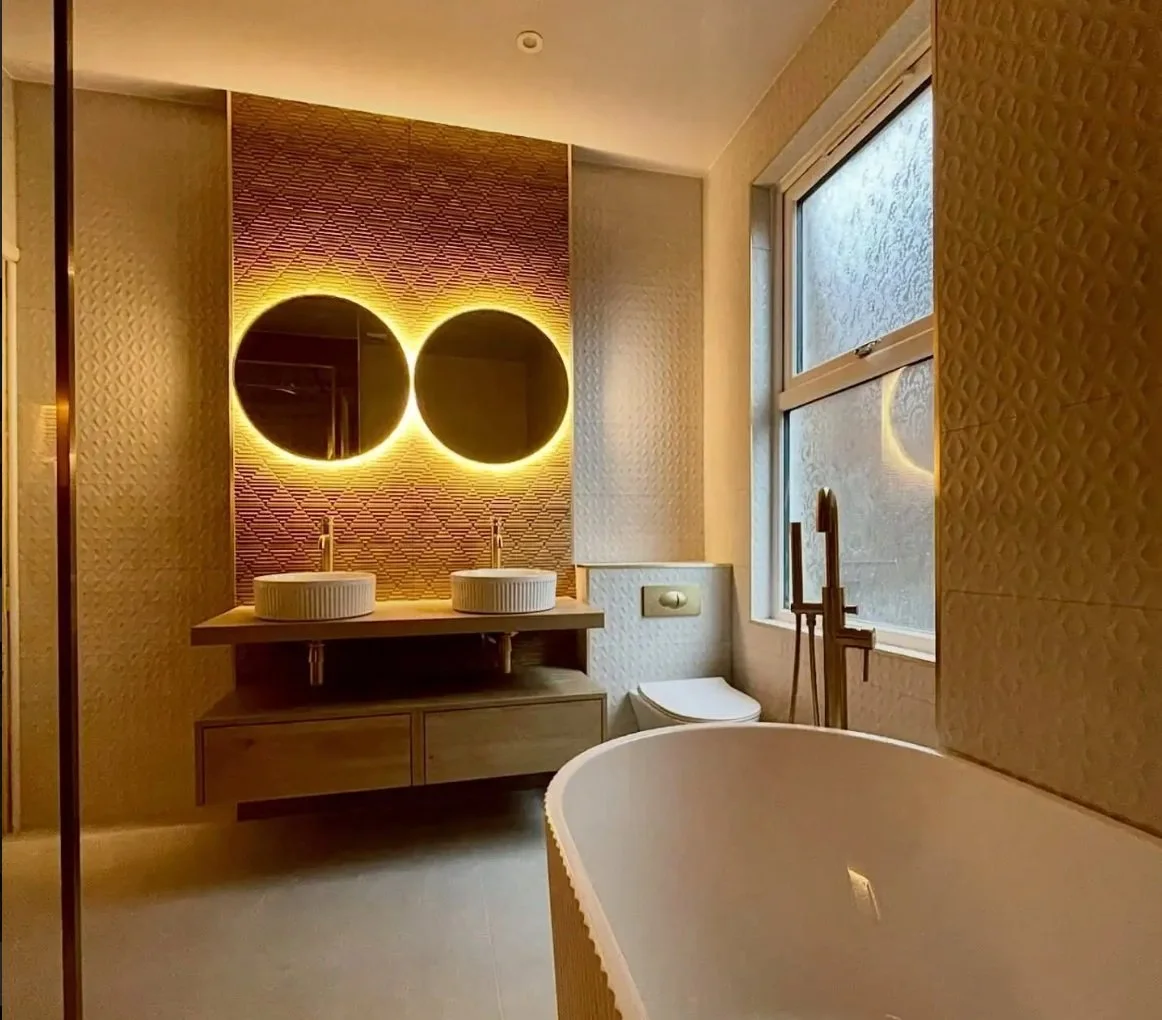 Luxury bathroom renovation featuring freestanding bath and twin illuminated mirrors by Stunning Bathrooms Liverpool