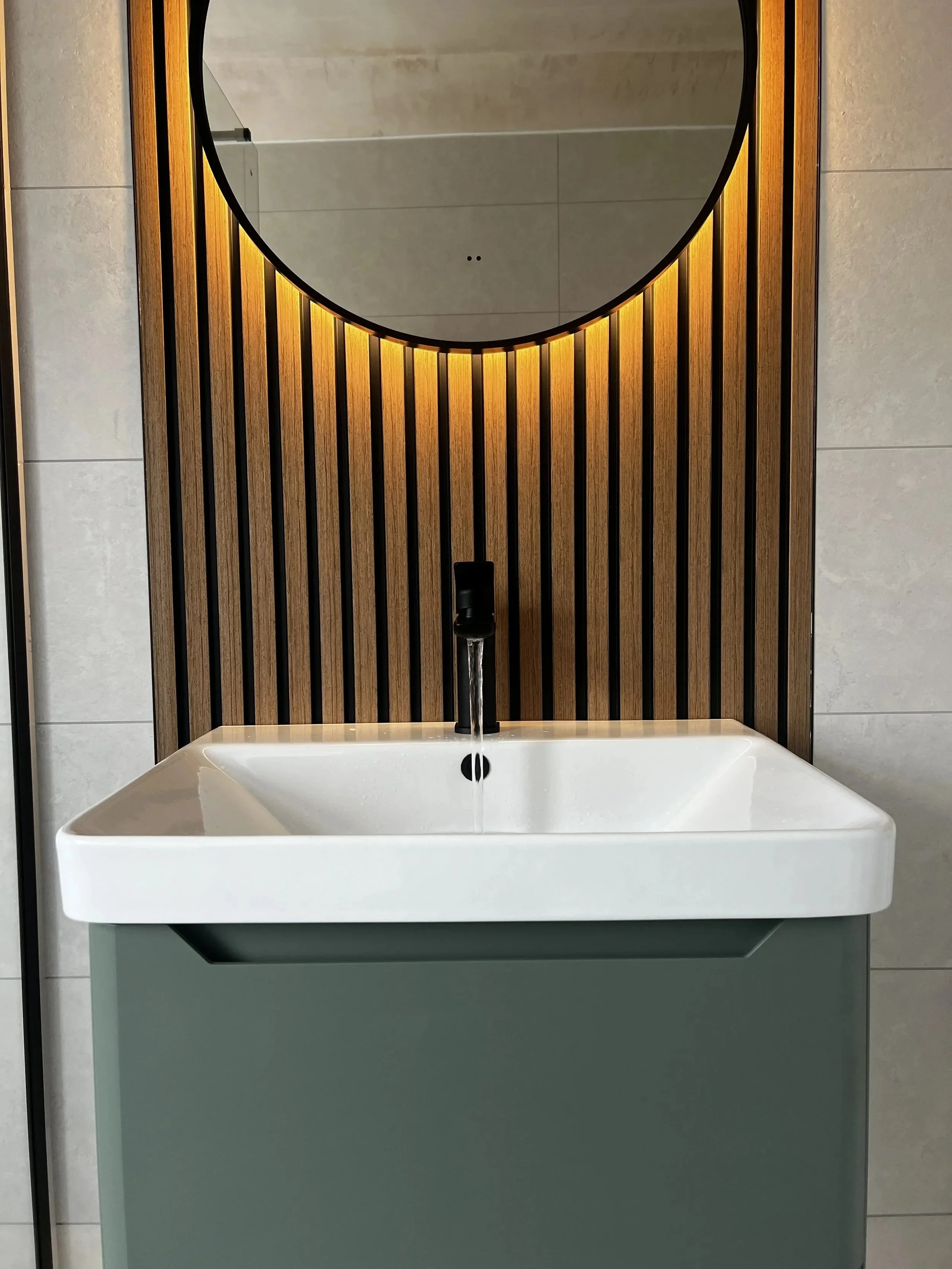 Contemporary bathroom design featuring wooden slat wall and modern basin unit in Liverpool home