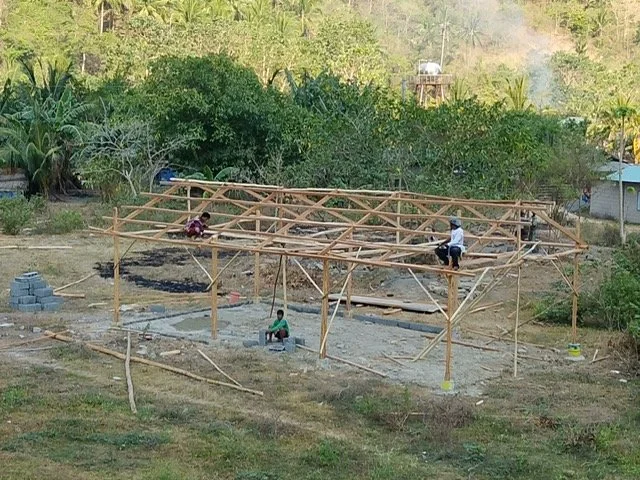 Three workers are building the new church