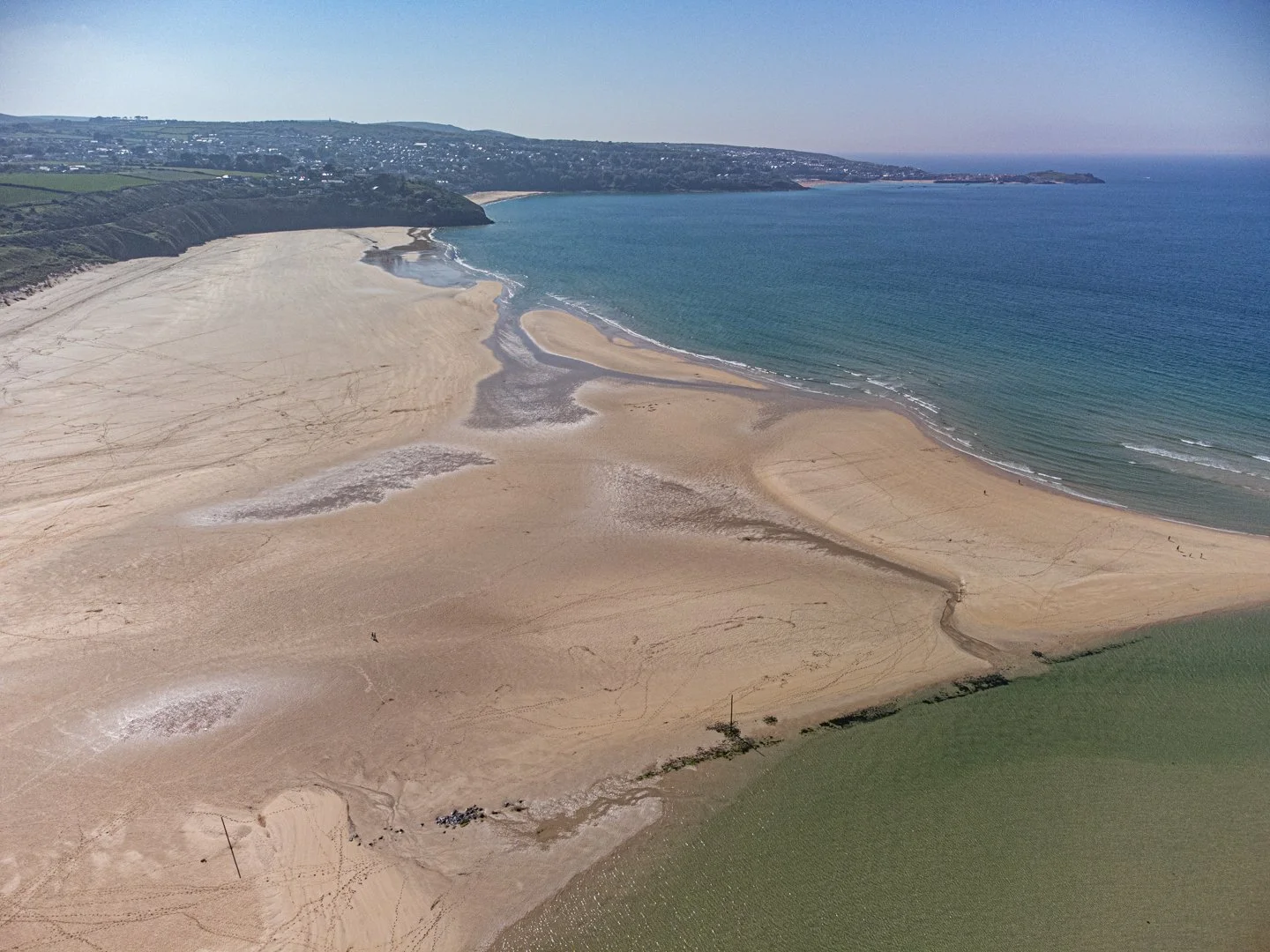 Porthkidney Beach with Carbis Bay and St Ives in the distance.