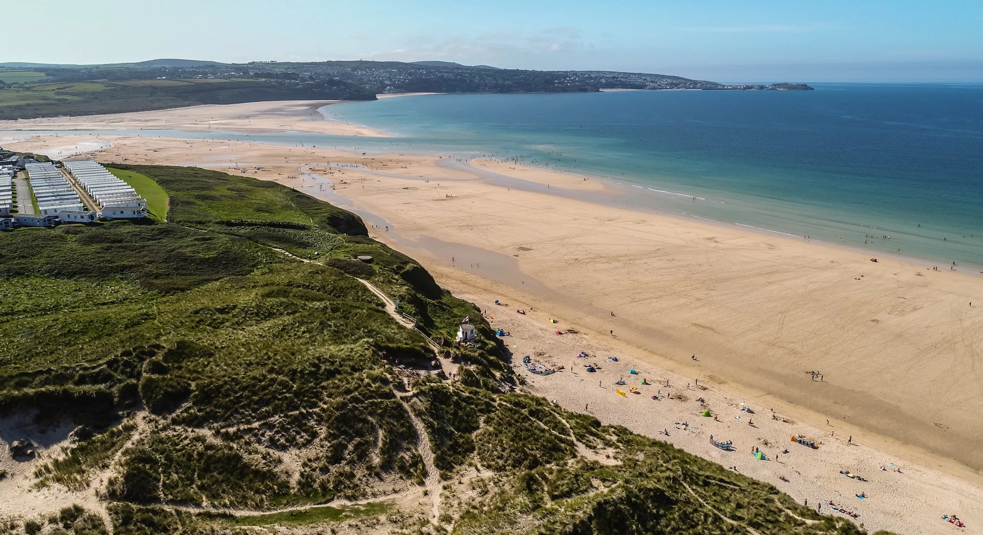 Hayle beach on a summer's day looking towards Porthkidney beach and St Ives in the distance.