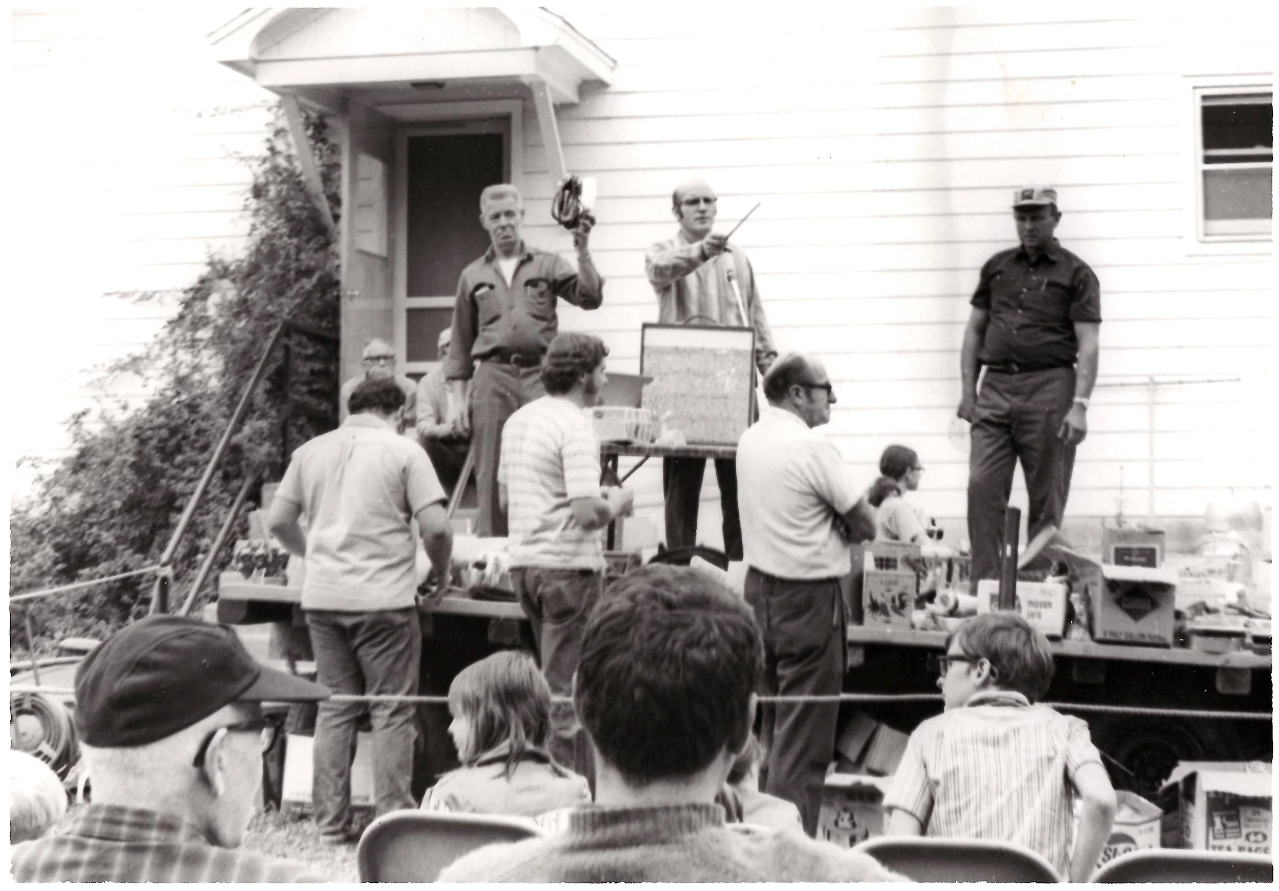 Lord's Acres Auction. Sept 19??. George VanEtten (Auctioneer). Wallace Quay Sr (to right). Marshall Steven (in front)