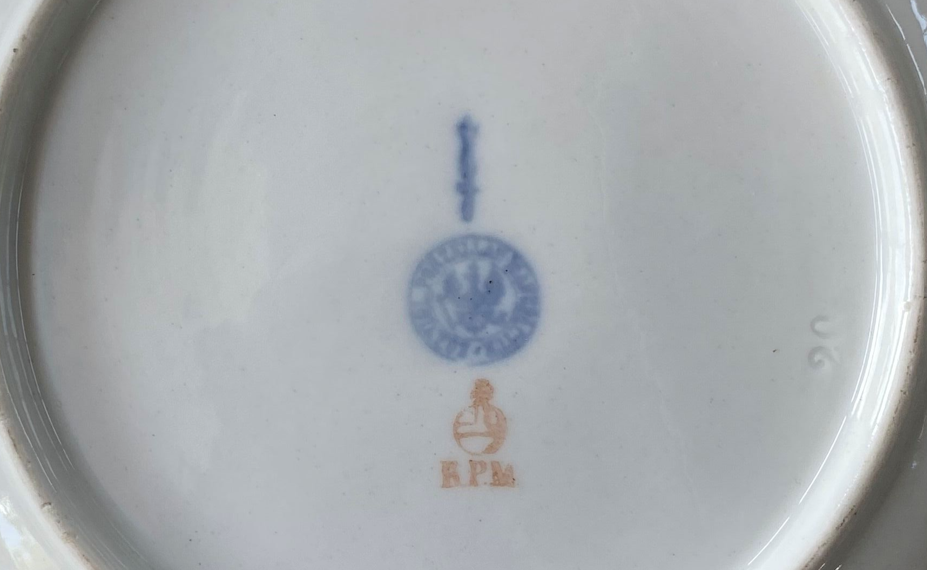 KPM Berlin porcelain base marks of the Englischglatt shape from the epoch 1849 to 1870 with underglaze blue scepter mark, red imperial orb and pressed Prussian eagle stamp.