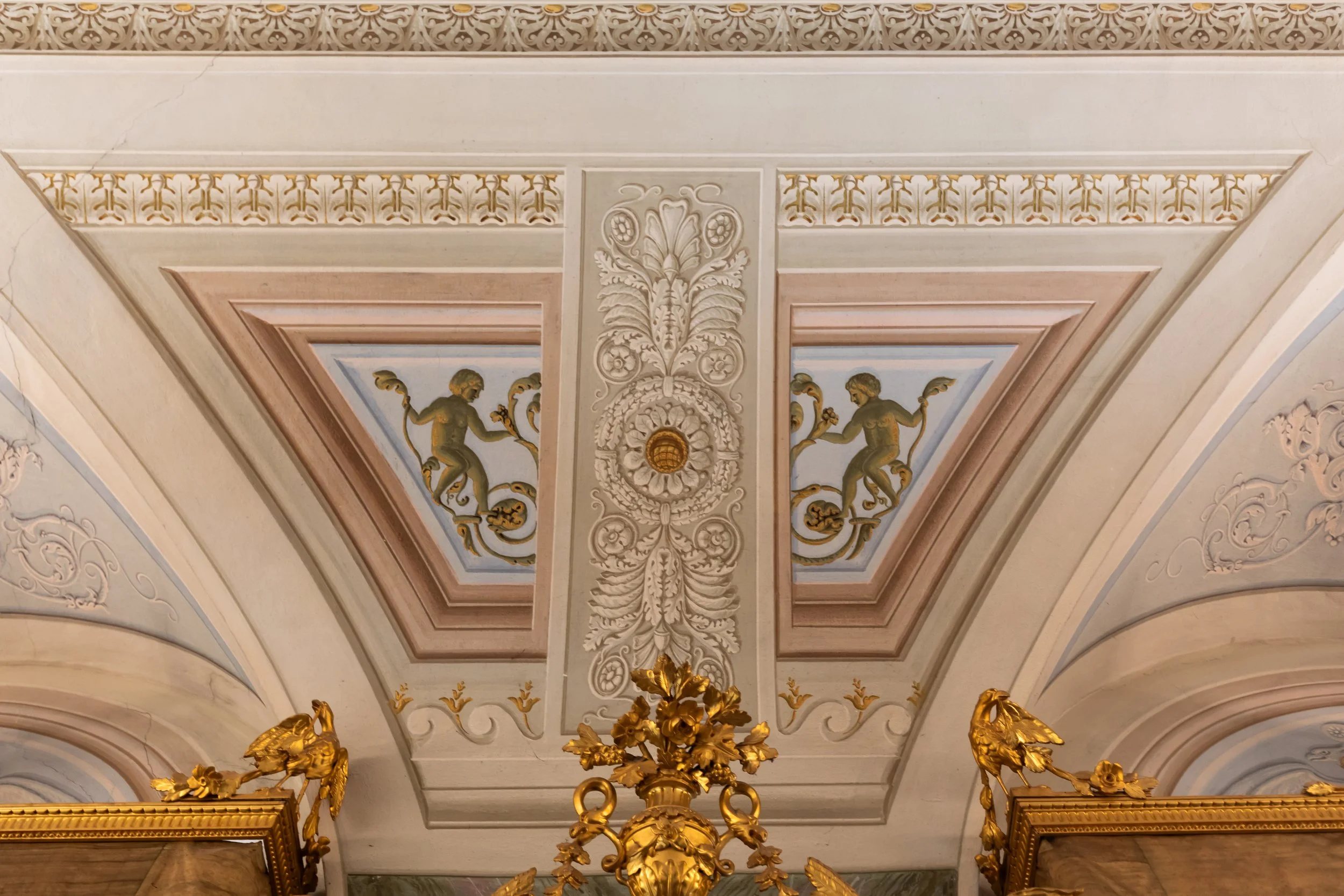 Ceiling with detailed decorative moldings, gold accents, and painted figures in classical style.