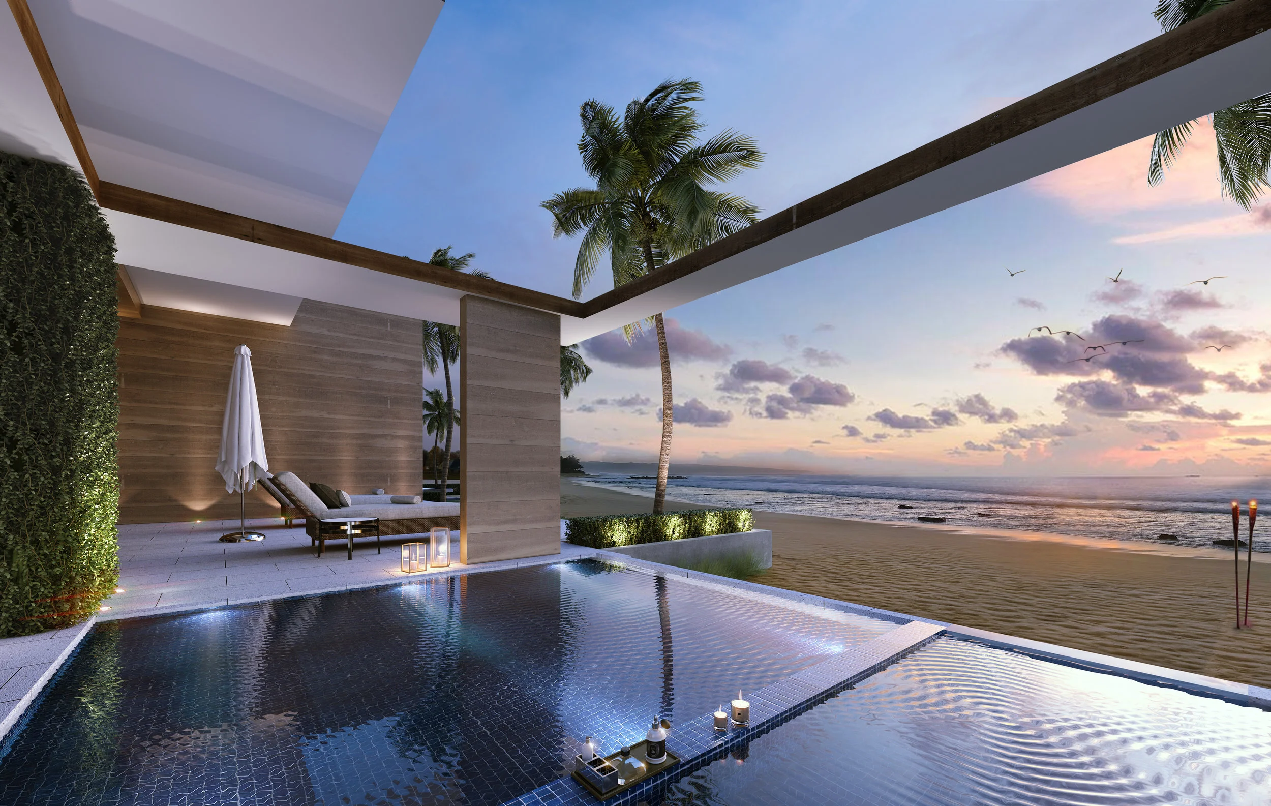 Luxury outdoor pool area overlooking a beach and ocean at sunset, with palm trees and modern lounge furniture.