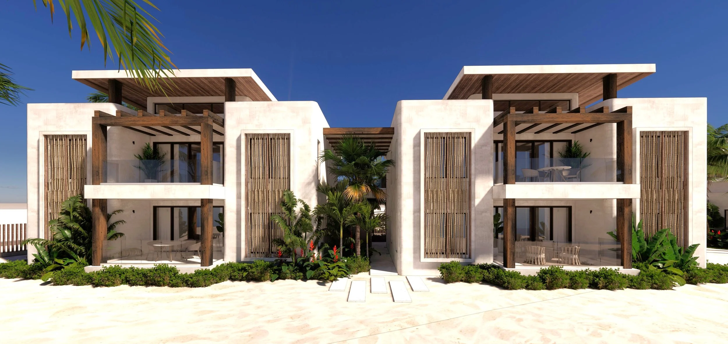 Modern beachfront residential building with white walls, wooden accents, large glass windows and sliding doors, lush tropical plants in front, and a clear blue sky.