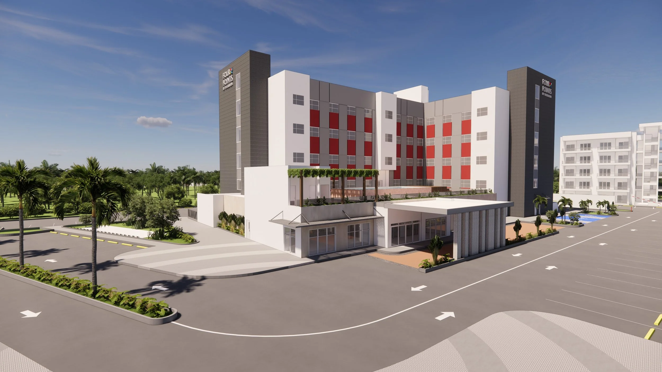 A modern multi-story building with a sign reading Four Points by Sheraton, surrounded by landscaped greenery, palm trees, and a parking lot with marked spaces and directional arrows.