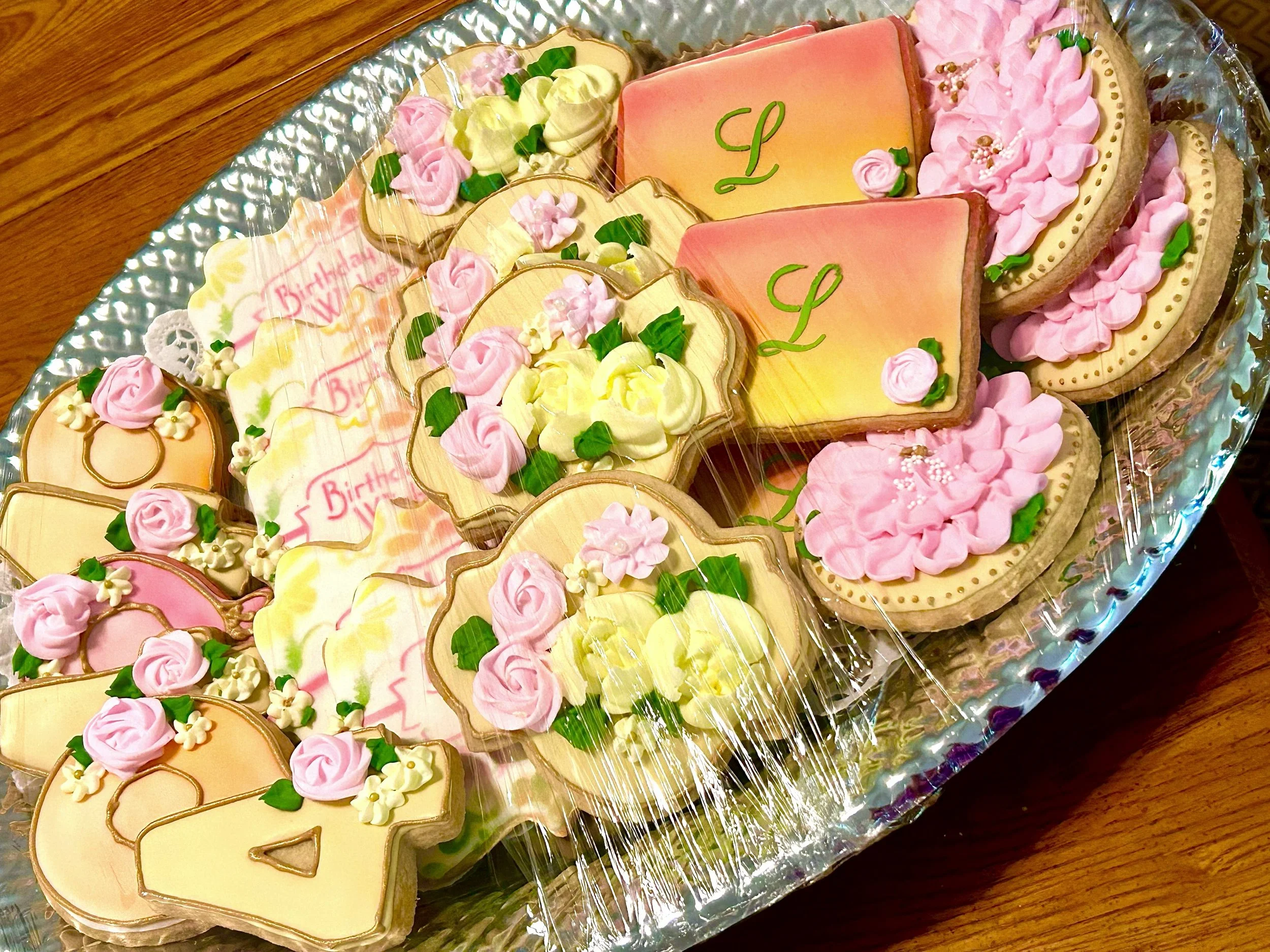 Fortieth birthday cut-out cookies decorated with floral designs in warm sunset tones
