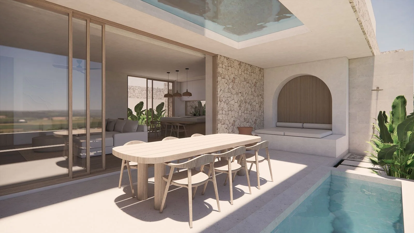 Modern outdoor patio with a wooden dining table and six chairs, a small pool on the right, and a built-in bench with an arched backrest on the wall. The patio is partially shaded and has a view of green landscape in the distance.