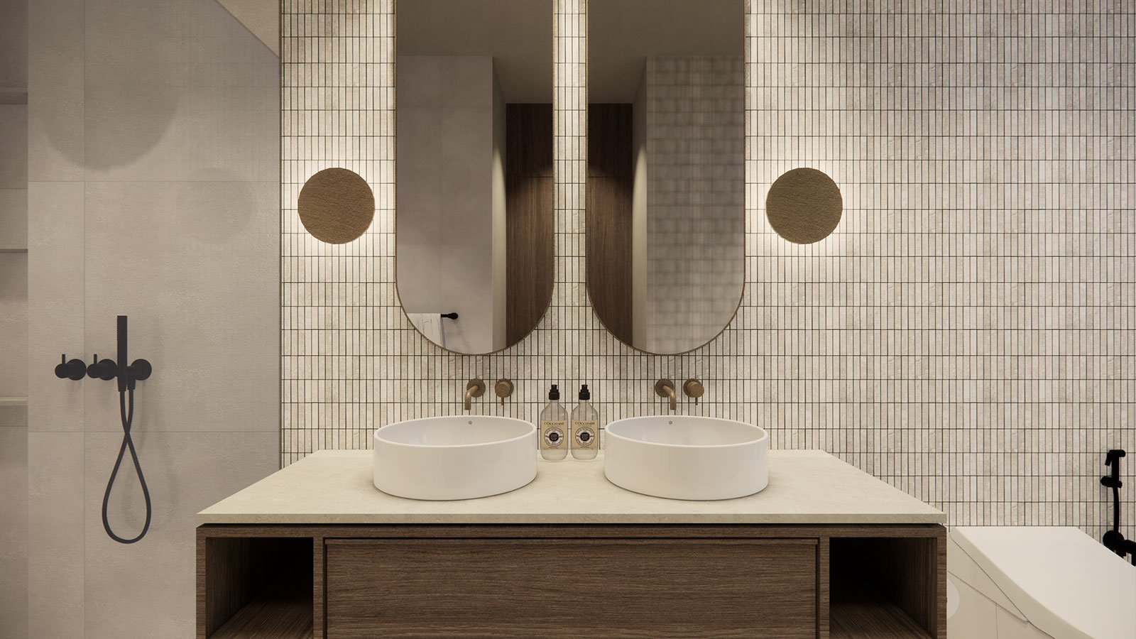 Modern bathroom with double oval mirrors above a double sink vanity, two soap dispensers, and a bathtub with a black faucet, all set against a tile wall with small rectangular tiles.