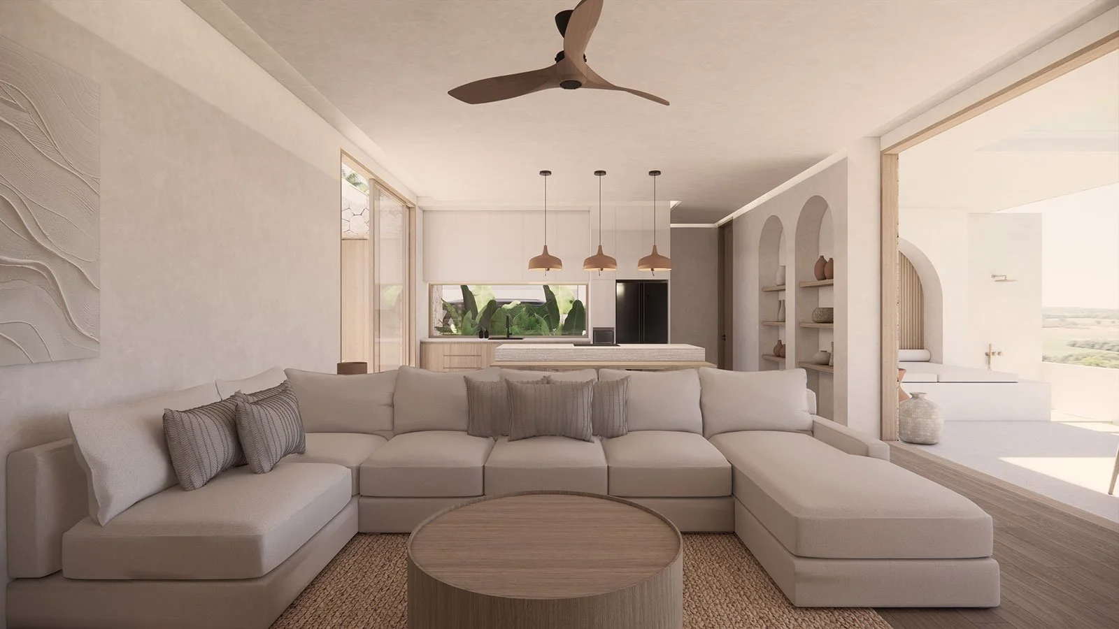 Living room with a white sectional sofa, neutral pillows, wooden coffee table, ceiling fan, pendant lights, open kitchen in the background, and large windows with outdoor views.