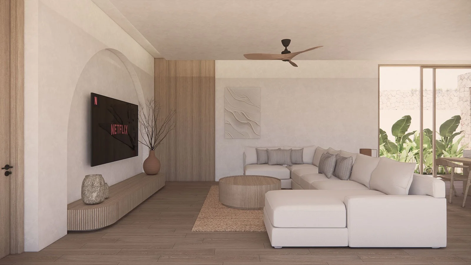Modern living room with white sectional sofa, wooden coffee table, TV mounted on wall, decorative vase, artwork, and large sliding glass doors with green plants outside.