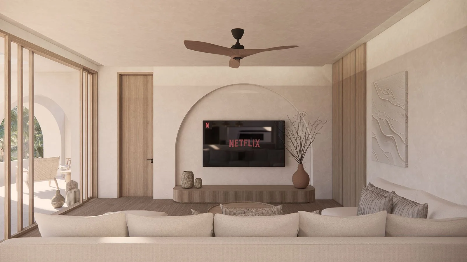 Living room with beige couch, wall-mounted TV displaying Netflix, decorative vases, a large vase with dried branches, wooden accents, and a ceiling fan