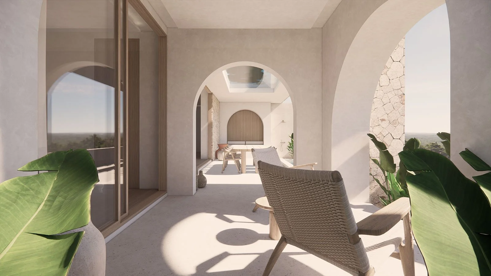 Sunlit balcony with wicker chairs, lush green plants, arched openings, and a view of open landscape and sky.