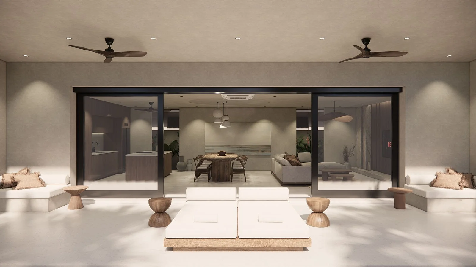Modern living room with sliding glass doors, white seating, and wooden tables, leading to a dining area with a wooden table and chairs, and a kitchen in the background.