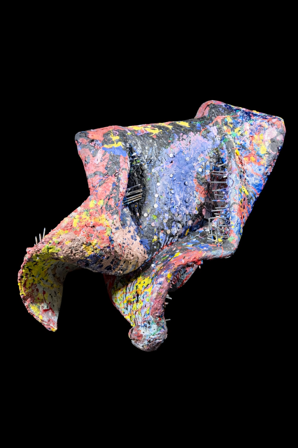 Abstract multicolored sculpture with spikes and layered textures on a black background.