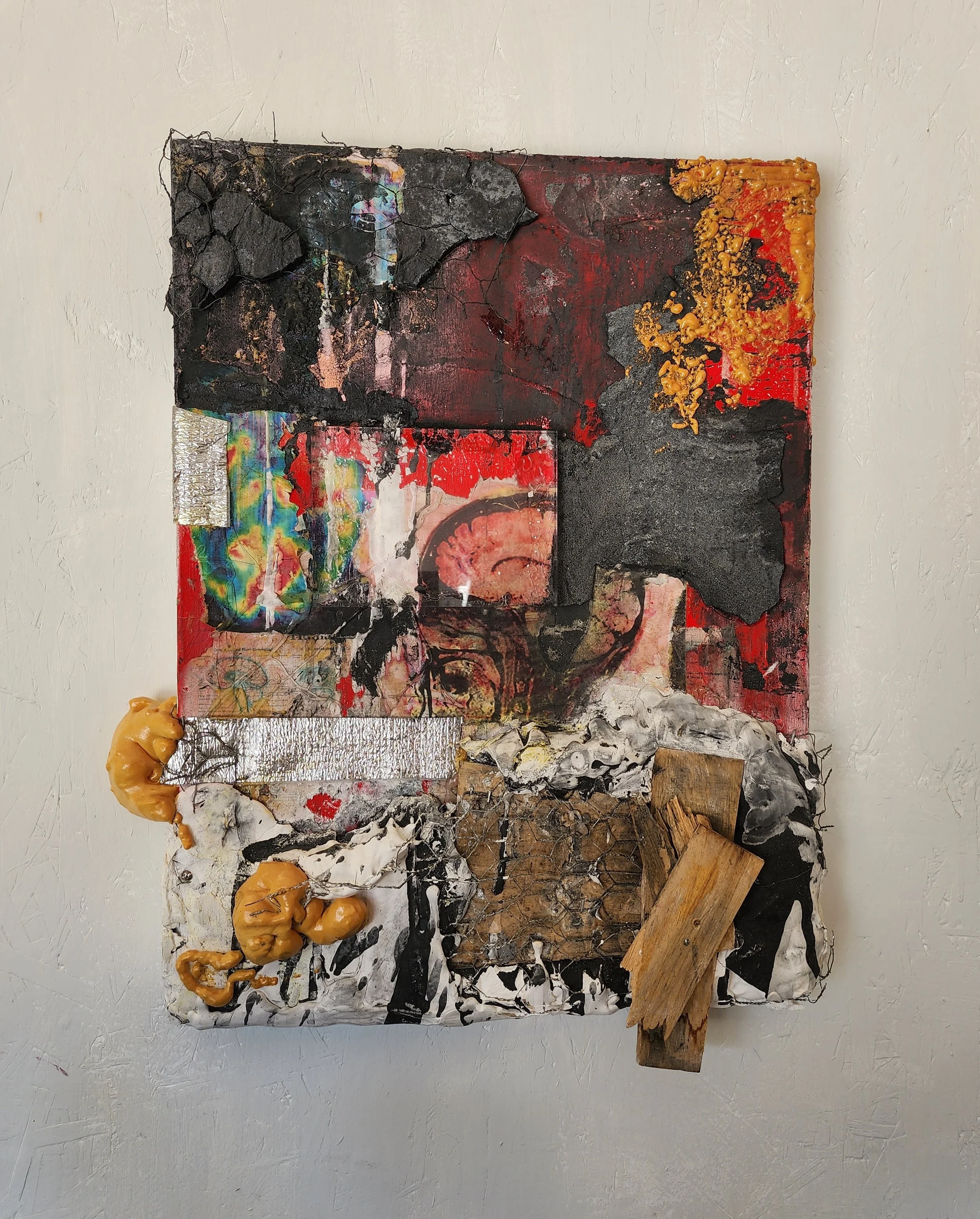 Mixed media abstract artwork with textured elements, collage, paint, and various materials including wood and fabric.