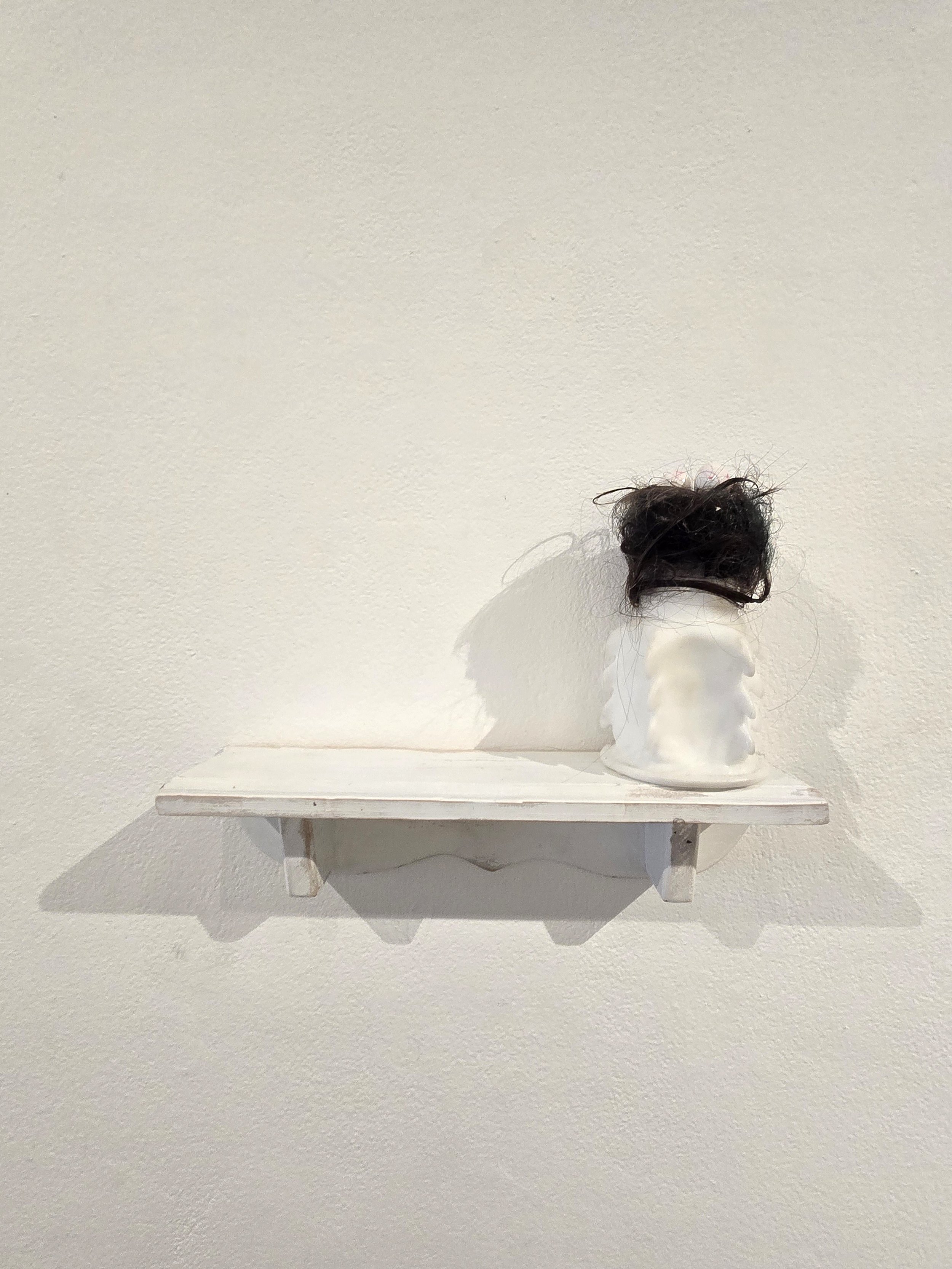 white glass anti rape condom with hair nest on top and 3 eggs