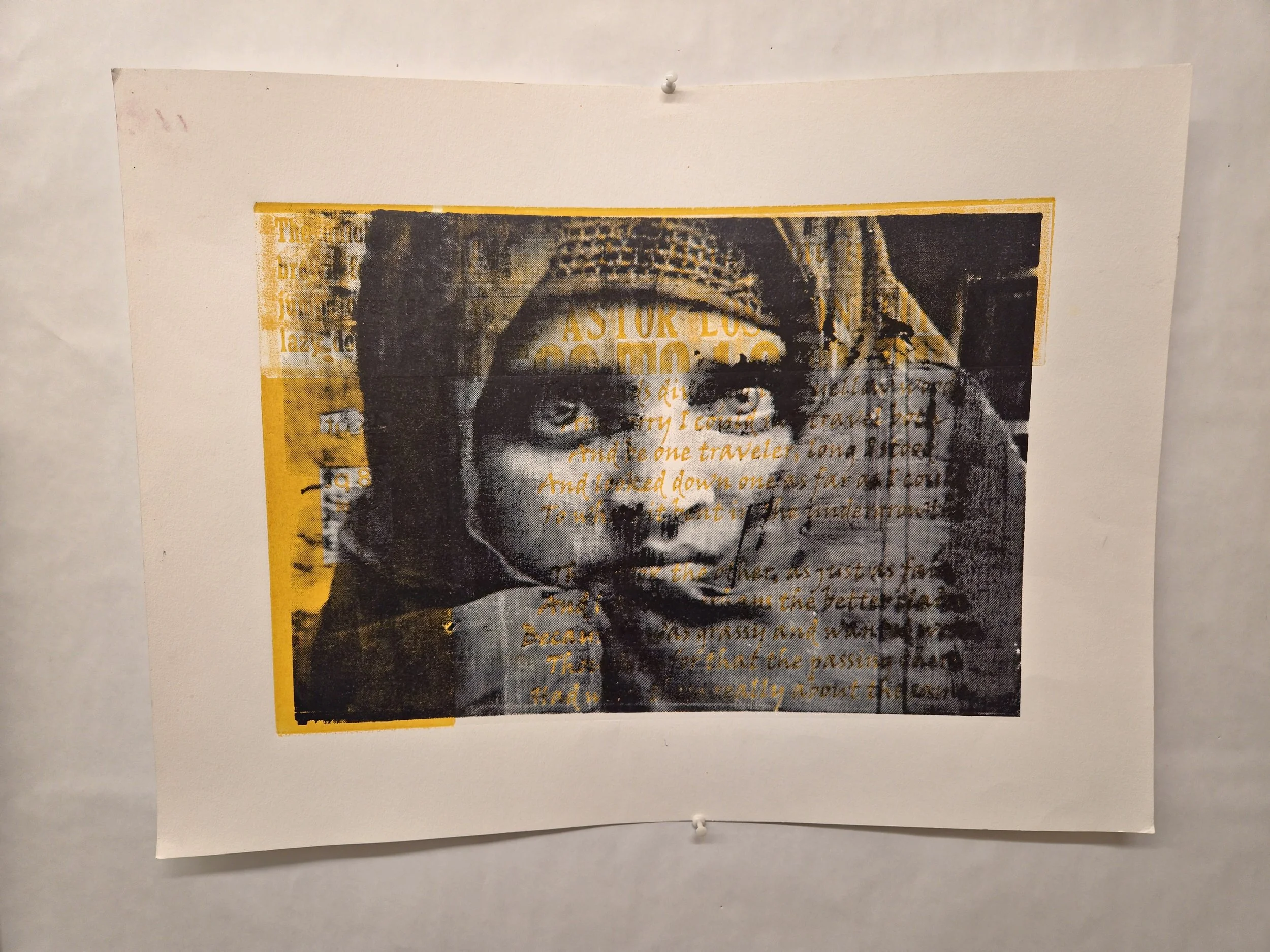 A printed poster of a woman wearing a headscarf, with overlaid handwritten text in orange ink.