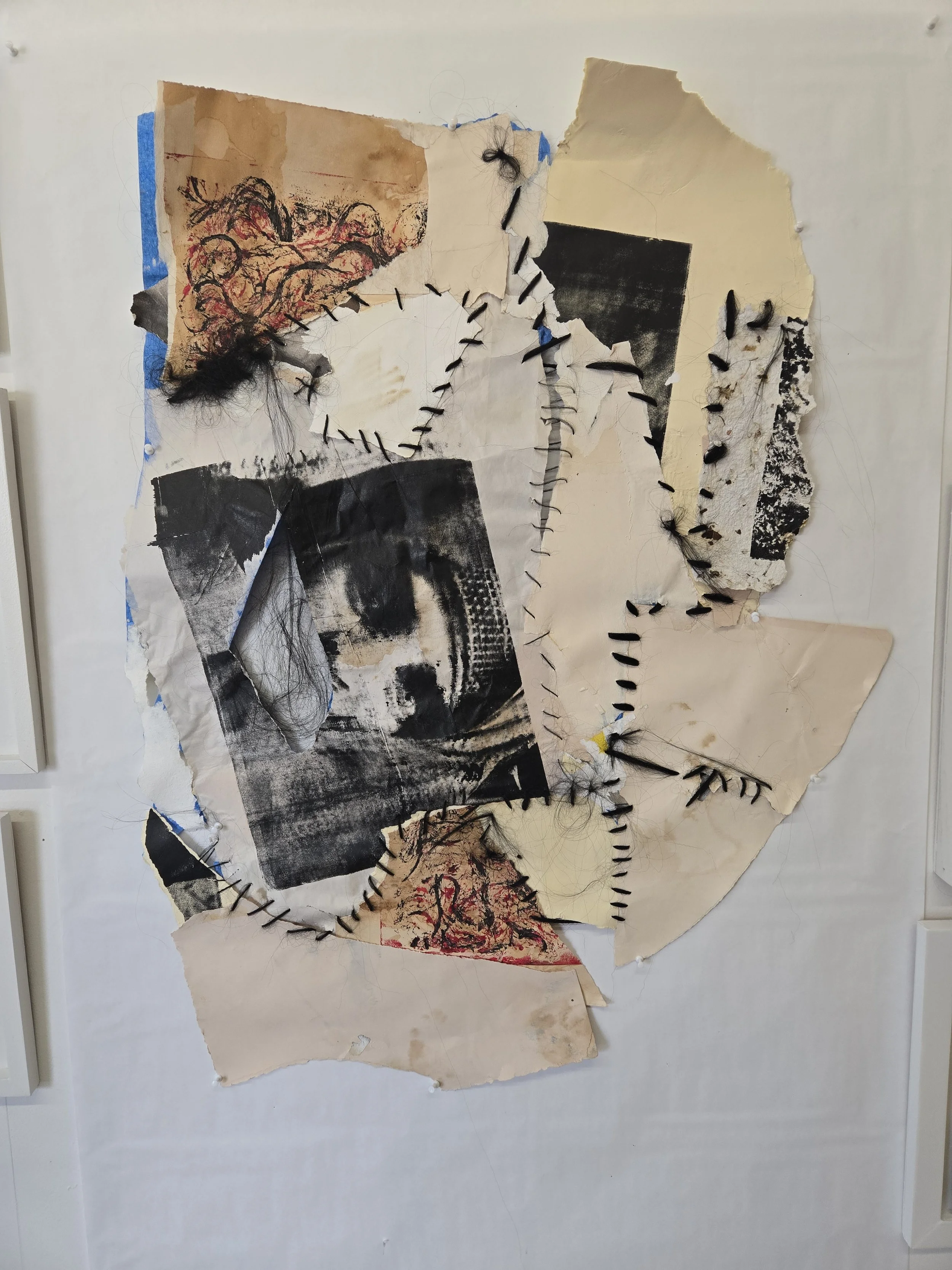 Mixed media collage artwork with torn paper, black thread stitches, and hair, featuring abstract images and sketches on a white background.