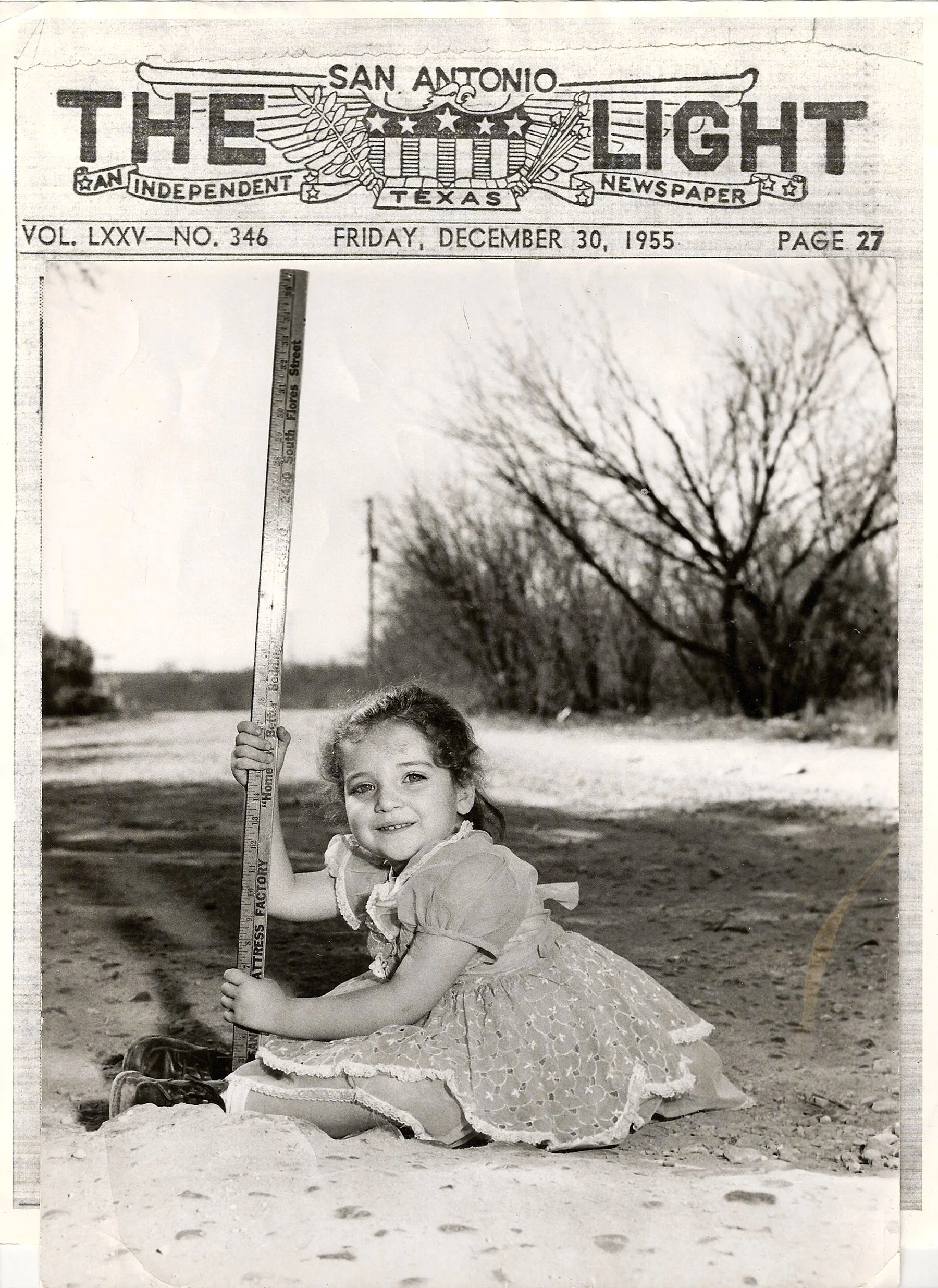 Carmen measures a chughole in front of her home on San Fernando St., an all-dirt street with huge chugholes. The people complained, embarrassed the City Council, and finally were victorious.