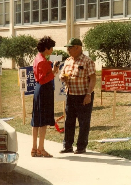 María Antonietta Berriozábal speaks to a citizen at the Ogden polling place, on election day in her campaign for City Council District 1, 1981. Courtesy of María Antonietta Berriozábal