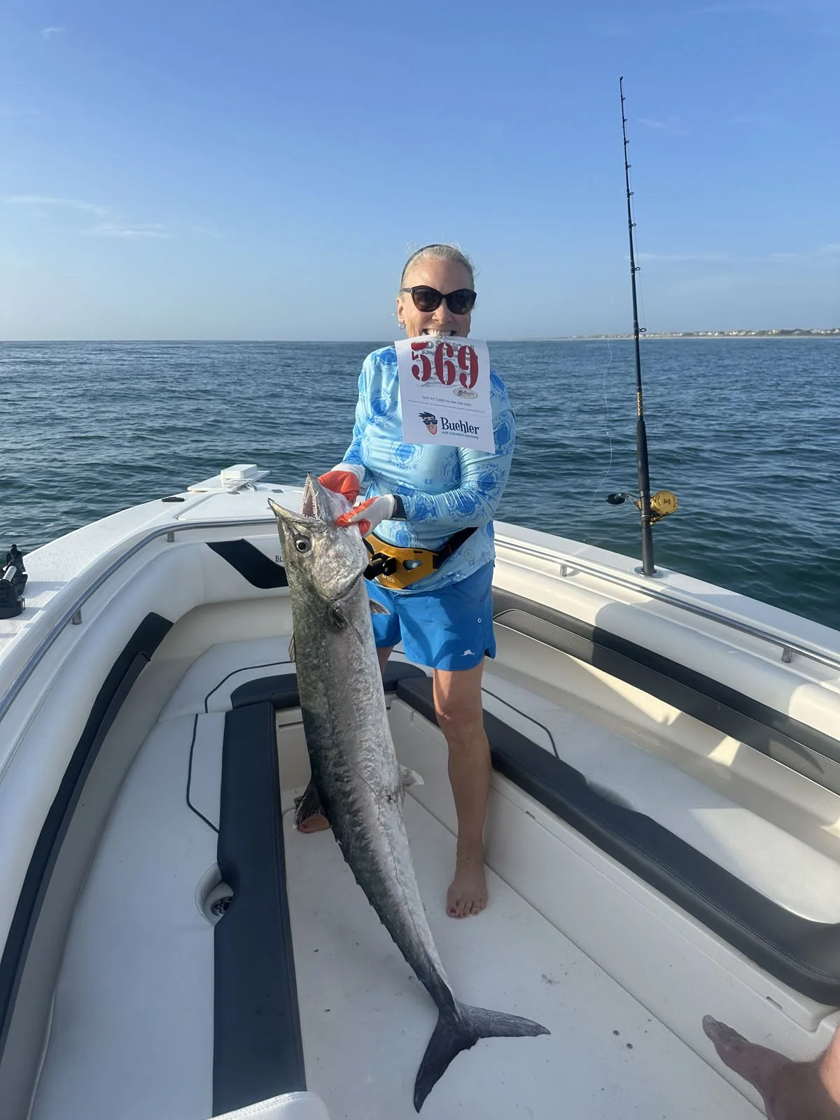 Female fisher with large kingfish for the jacksonville kingfish shootout