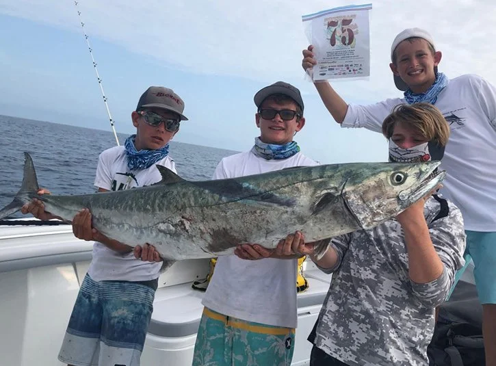 Kingfish Shootout Fishing Tournament showing young fishermen and their kingfish.