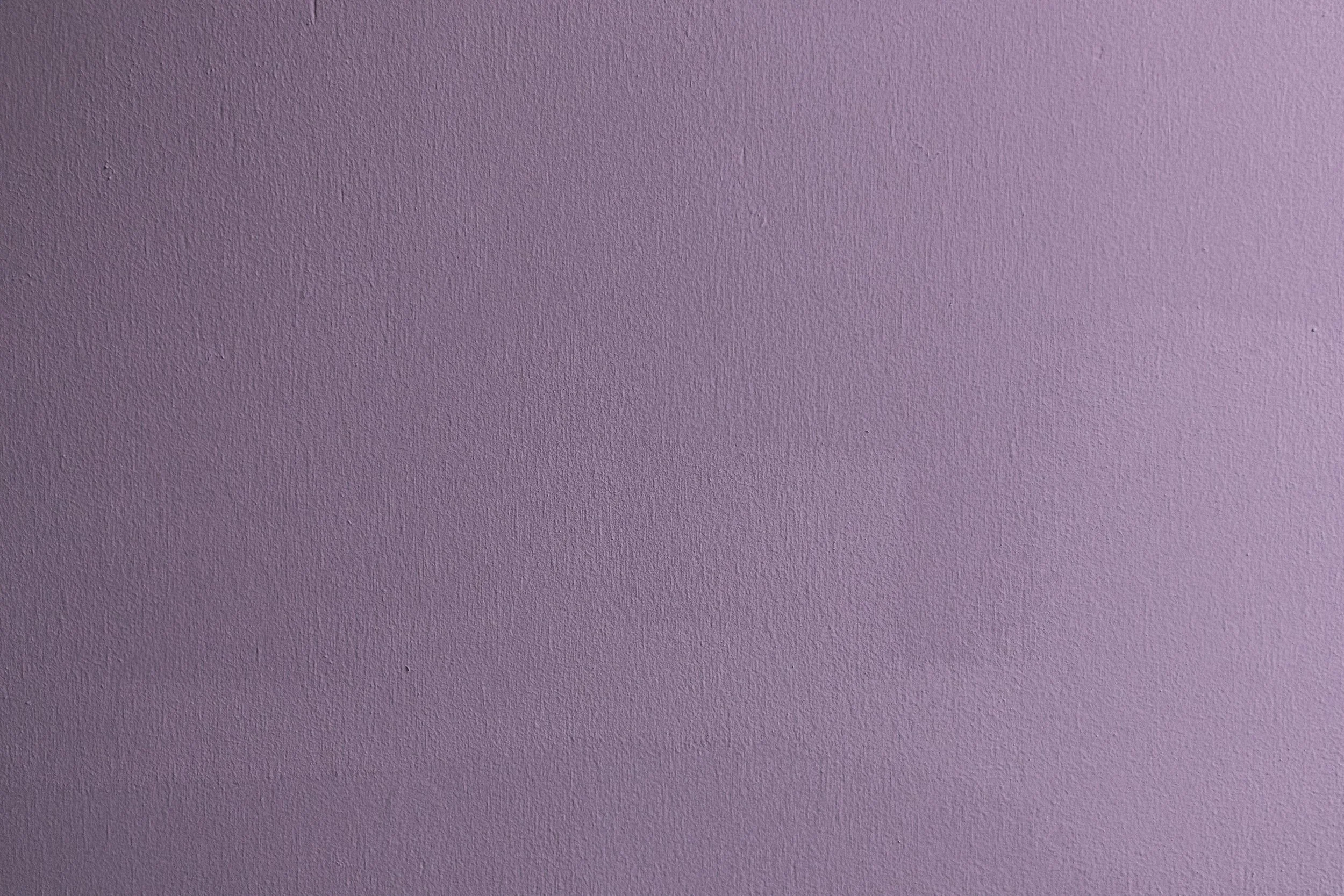 A pink, textured wall with no other objects or features visible.