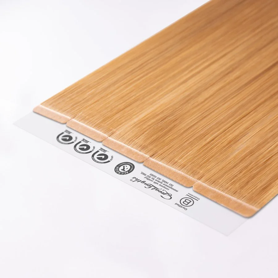 Close-up of a wood-look laminate flooring sample with a moisture barrier label underneath.