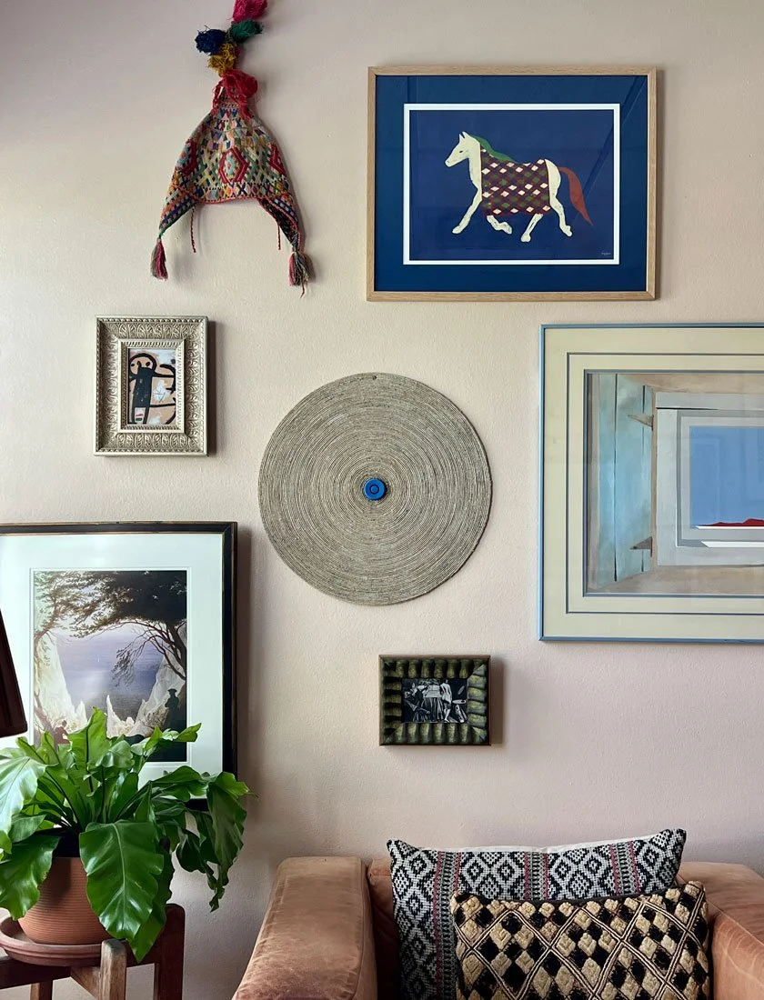 Decorative wall with framed artwork.