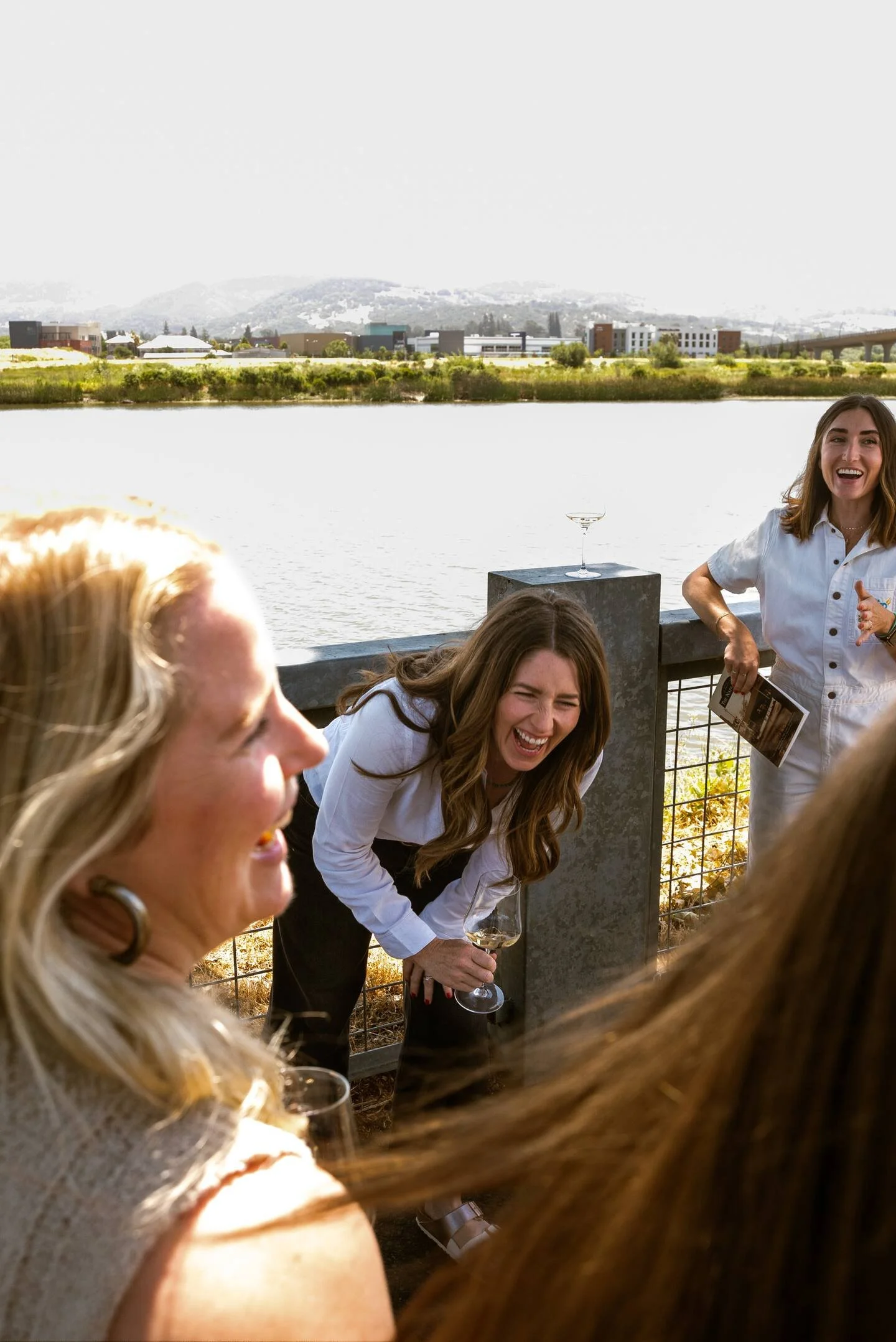 Alli van Zyl + Laura Gabriel hosting guests for wine along the Napa River at The River Club.