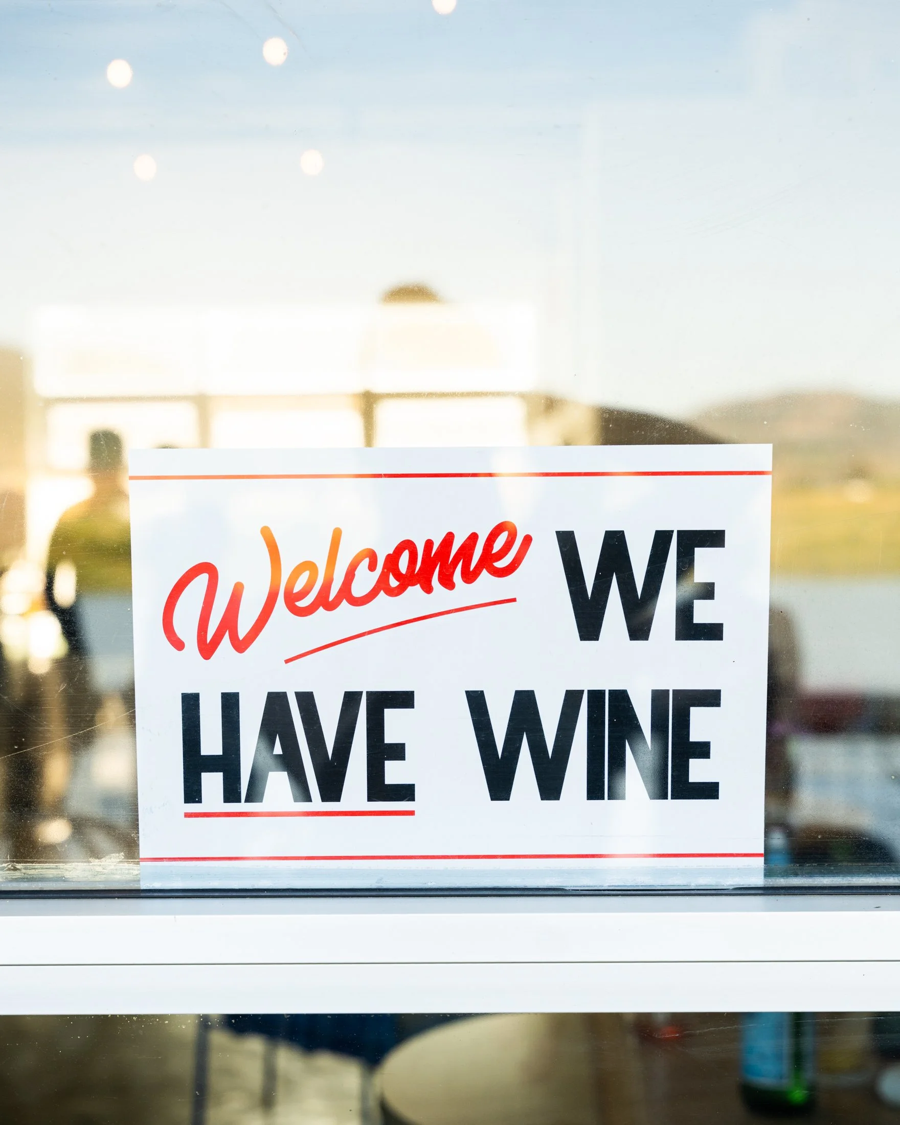 “Welcome, we have wine” sign at The River Club Napa